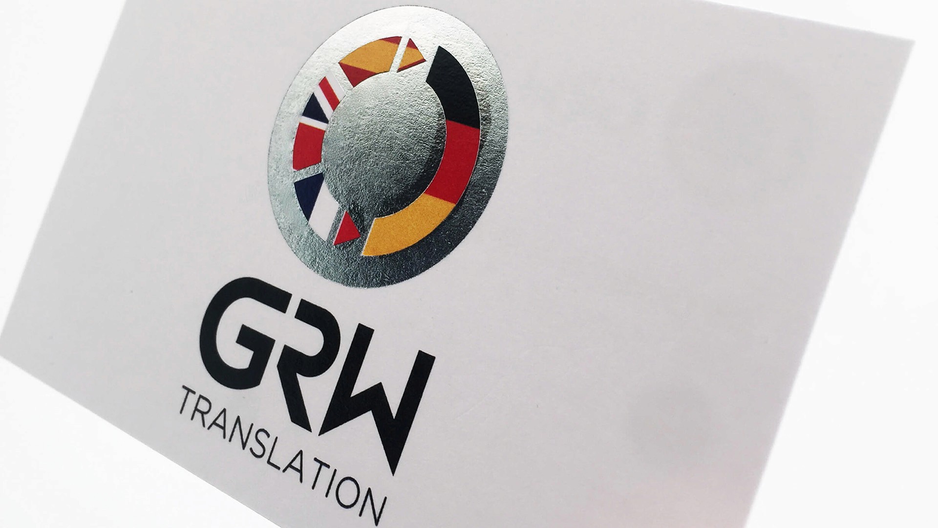 GRW Translation logo with silver foil finish on printed card stock by Huw Mathias graphic designer London