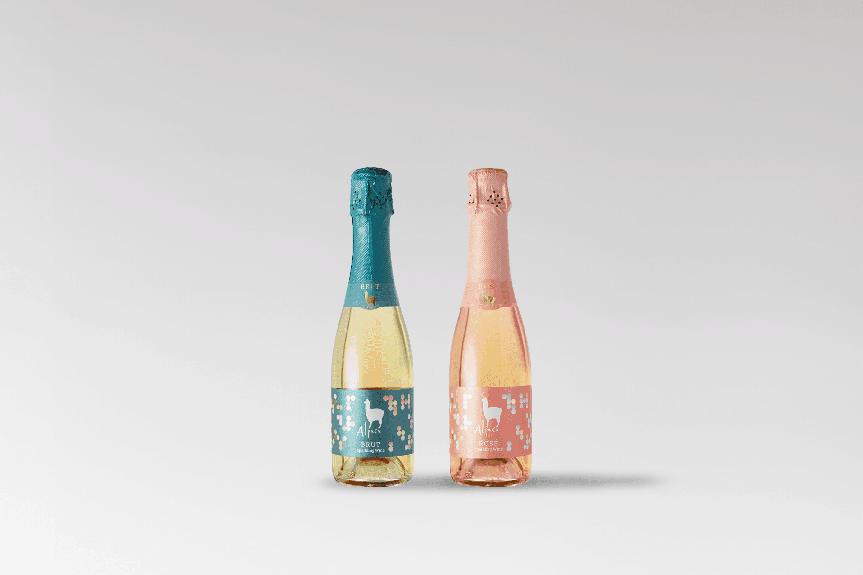 Two small Alpaca Sparkling bottles displaying the mint and pink packaging variations.