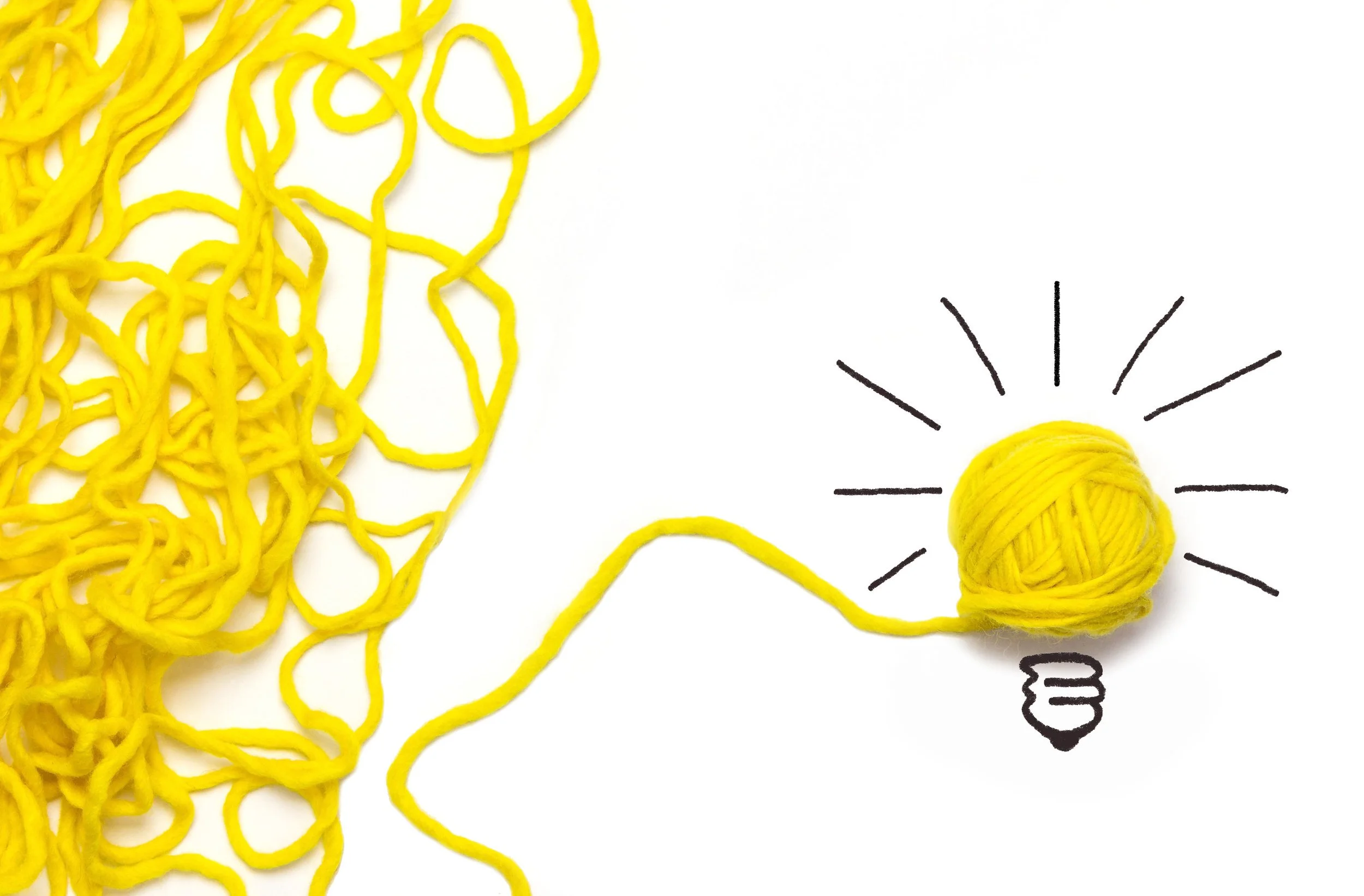 lightbulb made of yarn with loose yarn off to the side