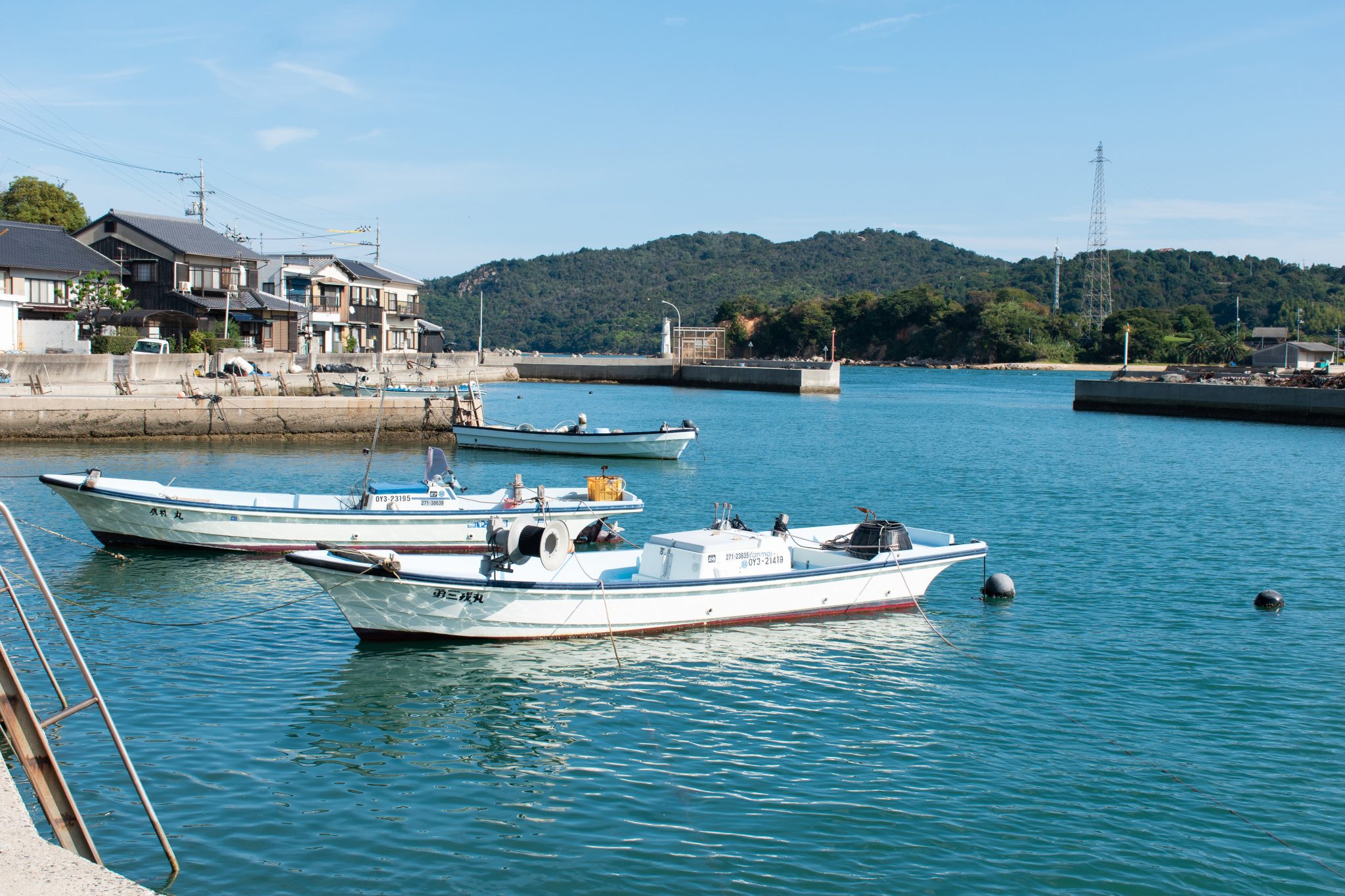 Two white motorbots parked in the blue Seto Sea
