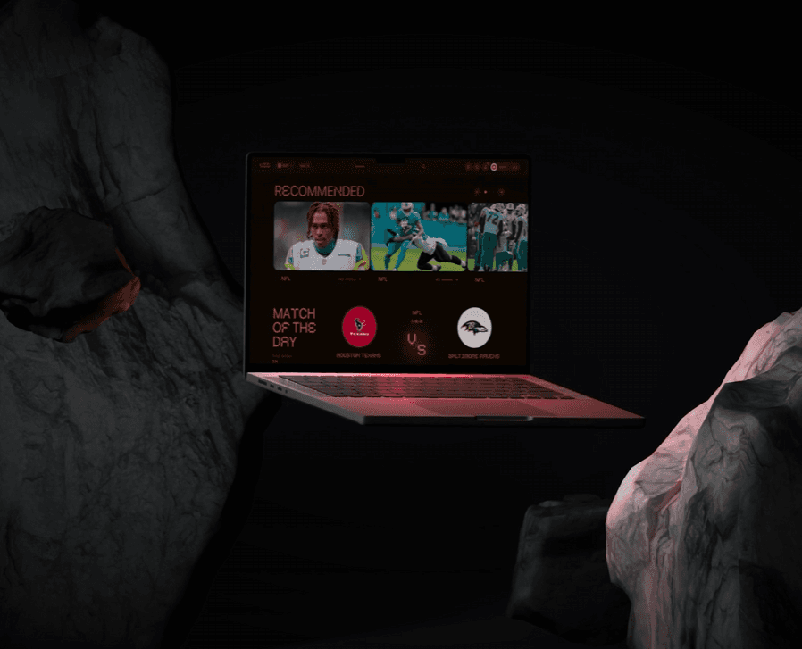 User interacting with sports dashboard on laptop in dark environment