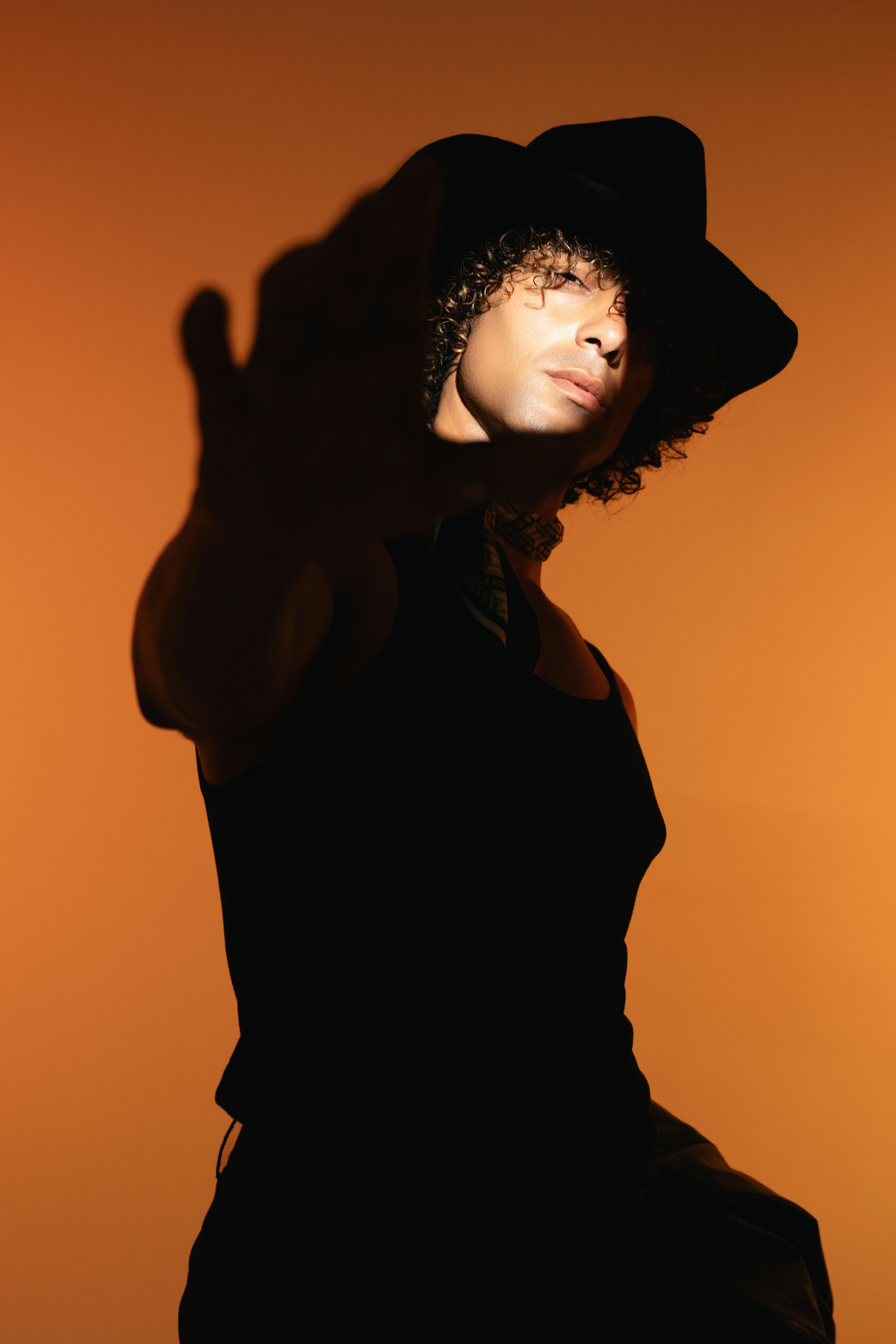 Man in western hat on orange background
