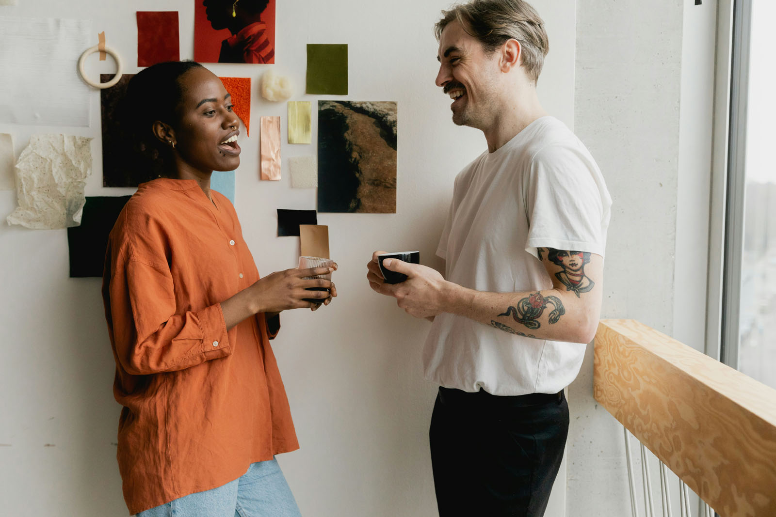 Two friends standing enjoying coffee