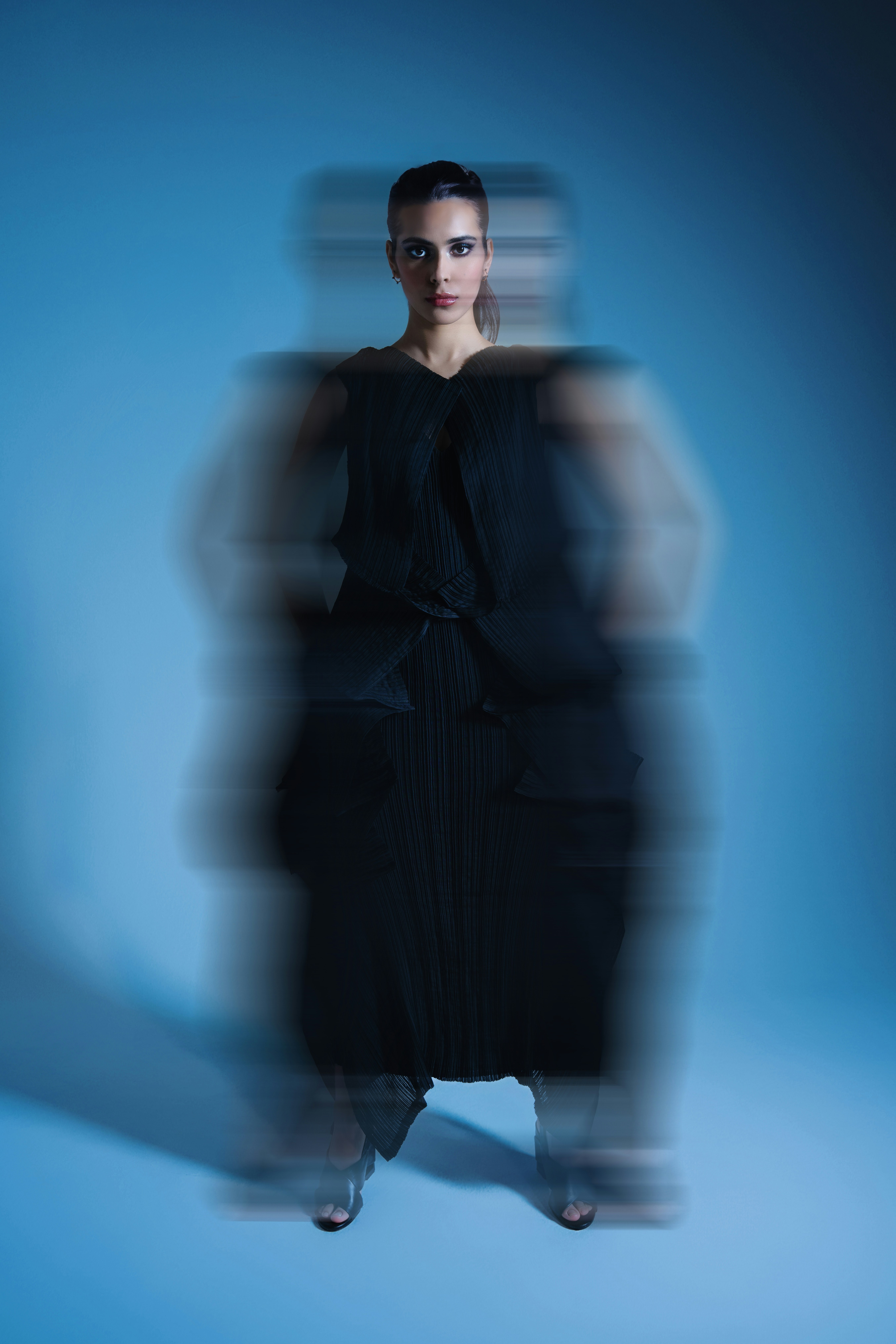 A blurry photo of a woman in a black dress