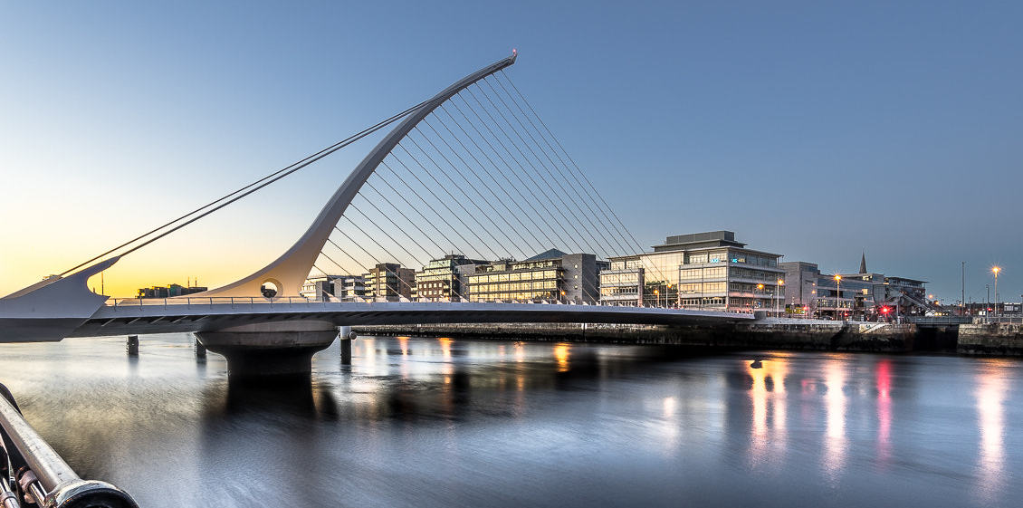 The iconic Samuel Beckett Bridge spans the River Liffey in Dublin at dusk, symbolizing the vibrant and modern city that hosts Investicon at the historic Irish Stock Exchange. Join us in Dublin for insights into stocks, AI, and whiskey investing. #DublinIreland #SamuelBeckettBridge #Investicon #IrishStockExchange #InvestmentConference #Cityscape