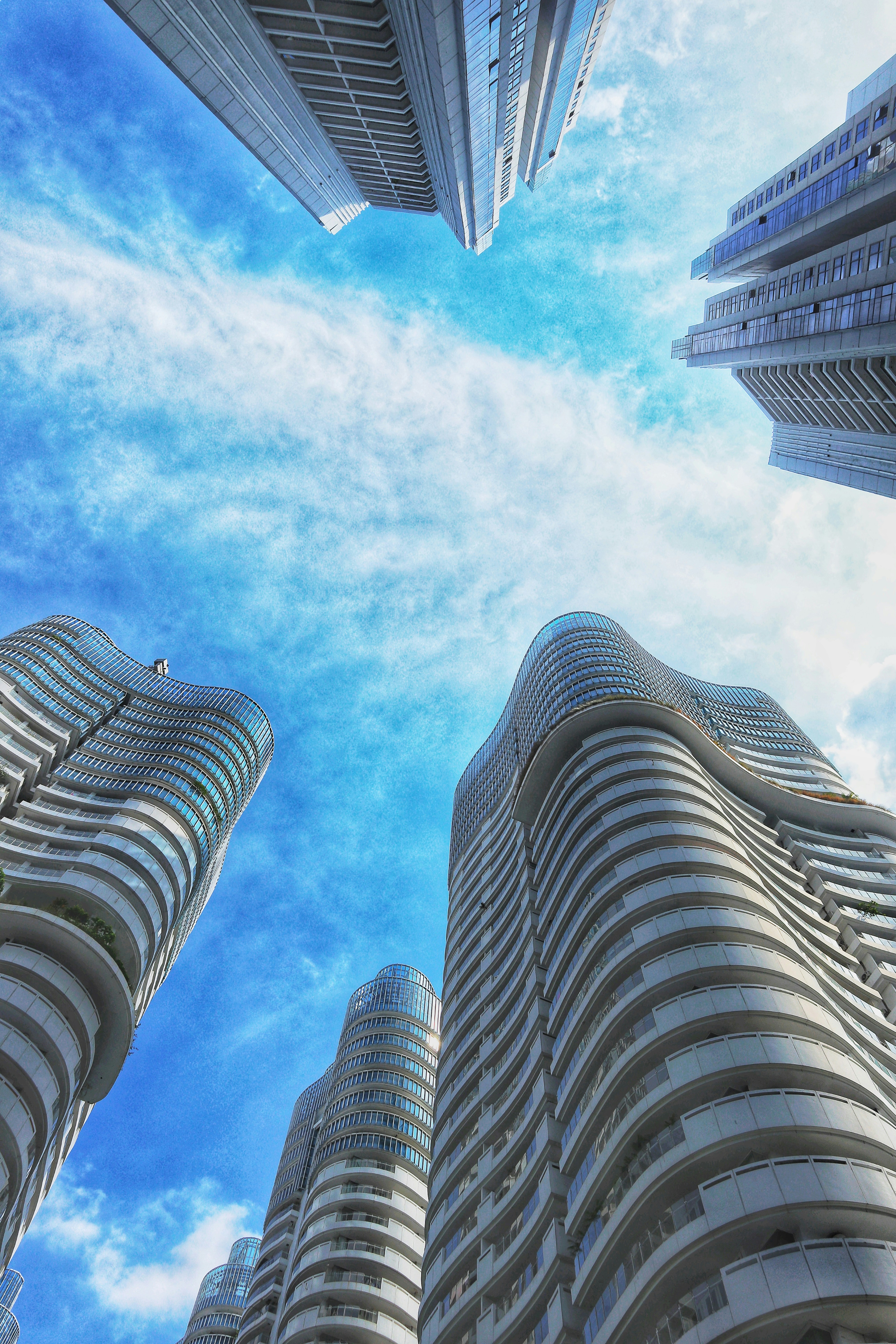 low angle photography of high rise building under blue sky during daytime