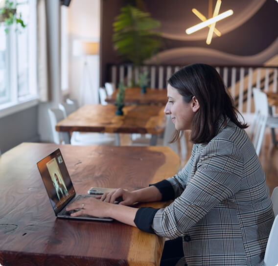 Modern professional woman working in a modern cafe on a laptop. 
