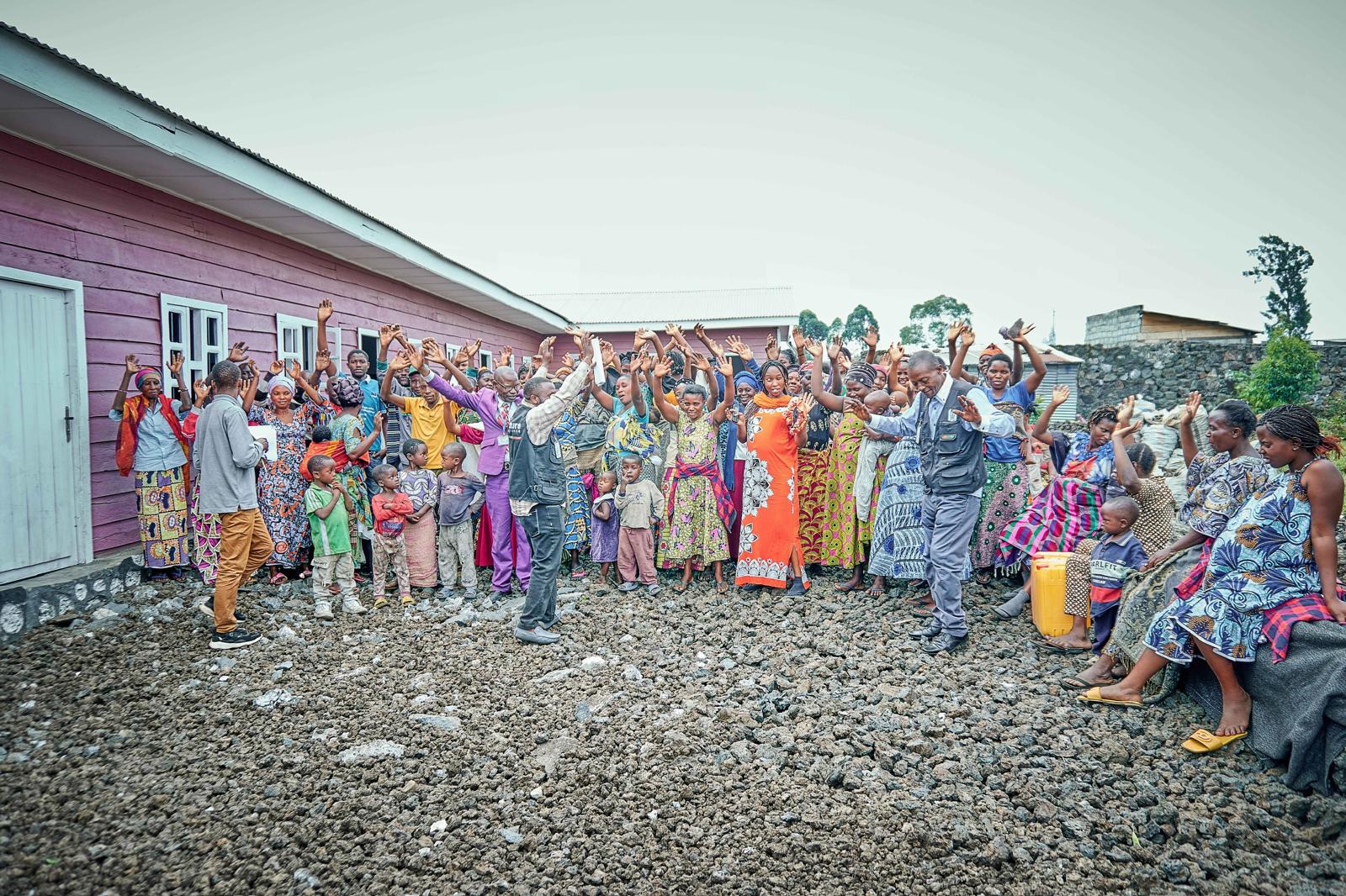 group of people standing near brown concrete building during daytime