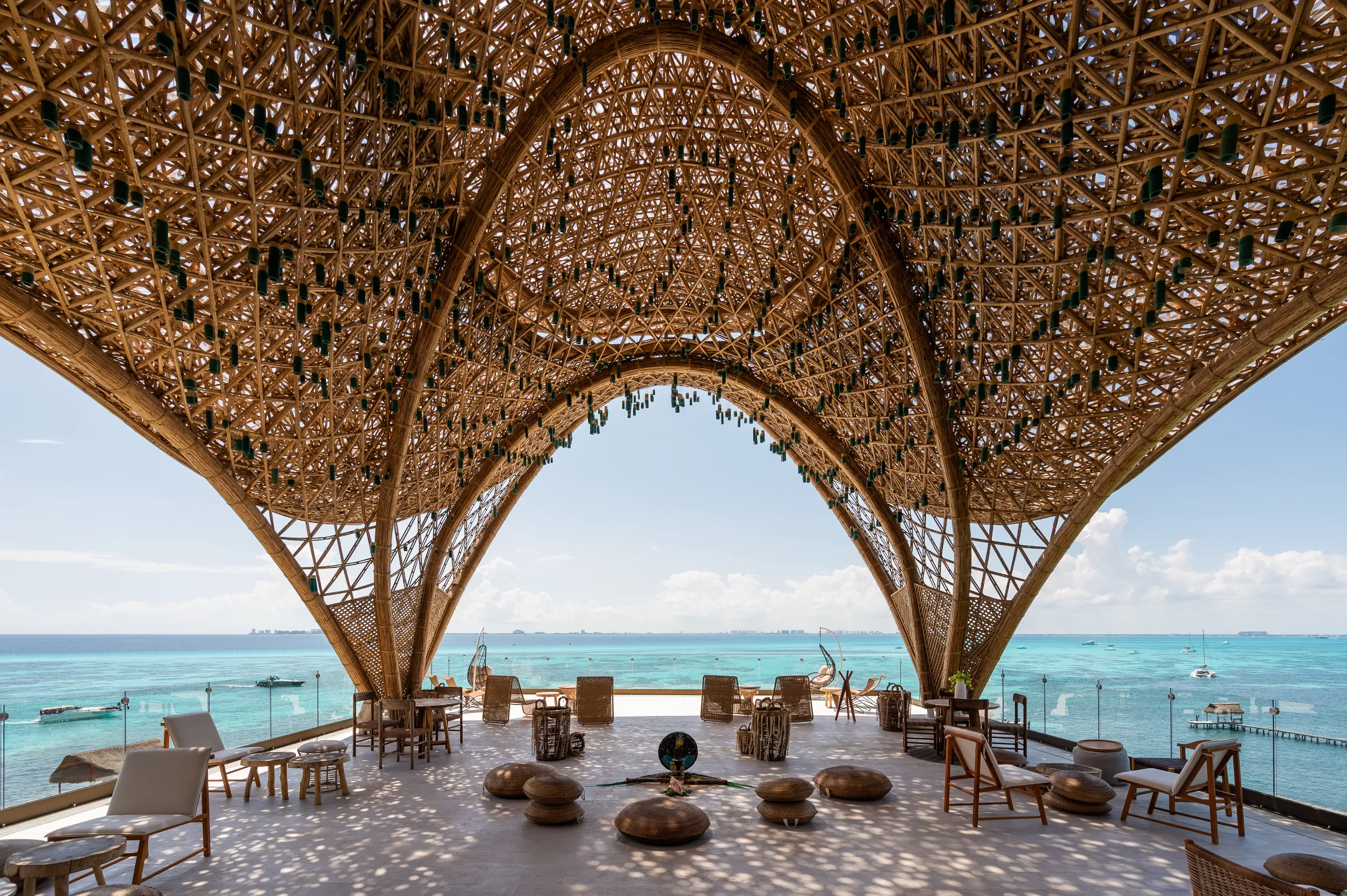 Interior view of The Temple at Hyatt Impressions Isla Mujeres featuring monumental bamboo catenary arches and panoramic Caribbean Sea views.