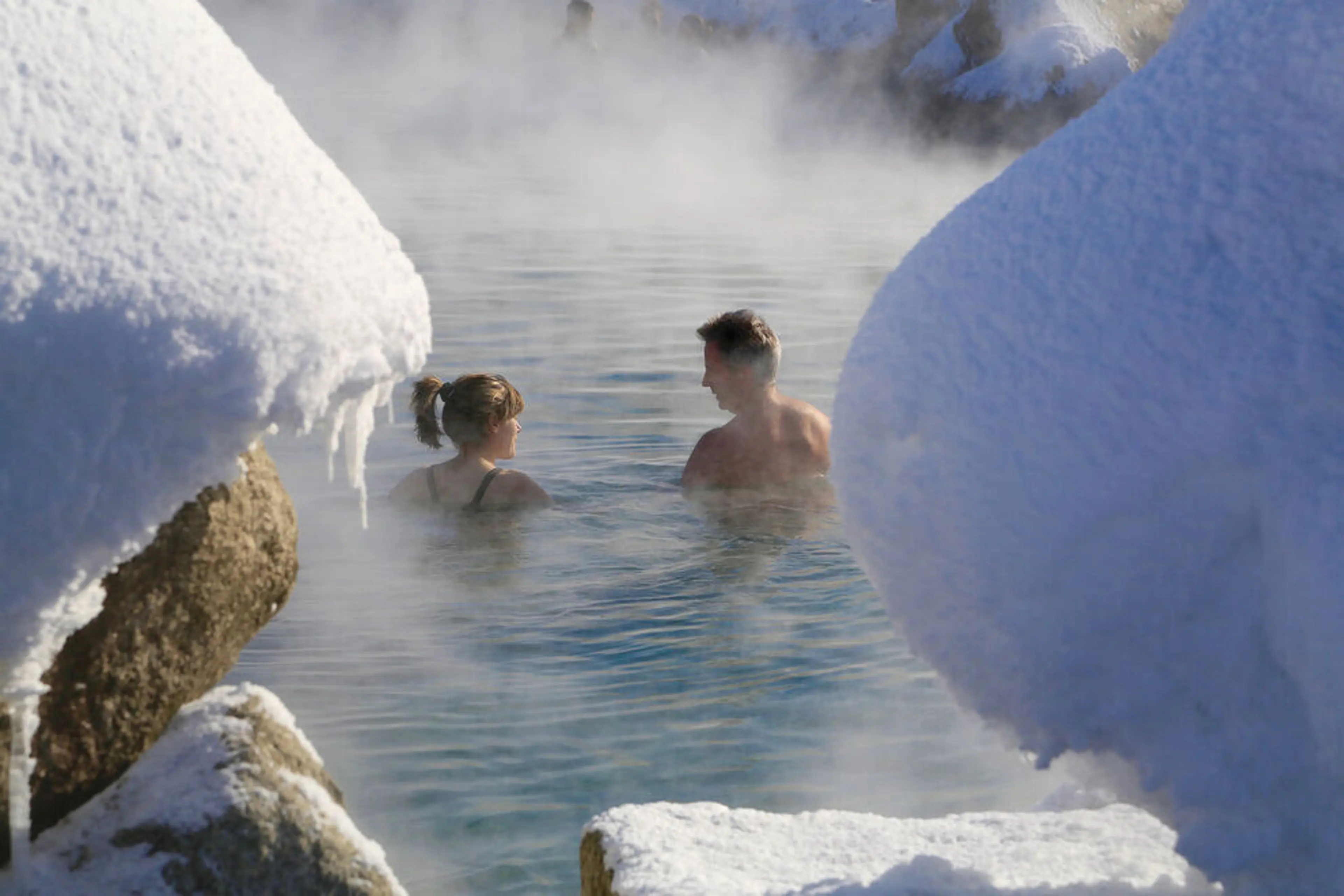 Snowy hot springs near Aspen during sunset with mountain views