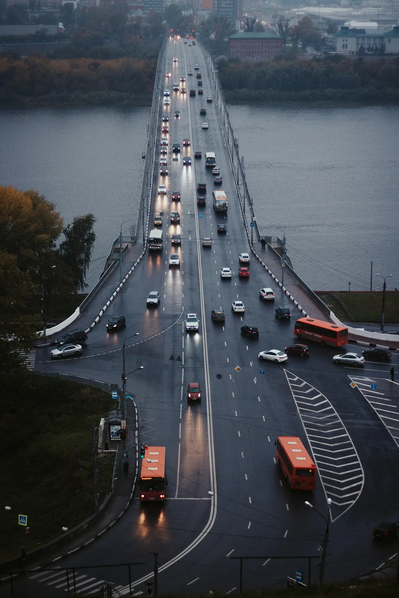 High-angle view of a busy city bridge with flowing cars and buses, a typical scene for traffic monitoring cameras analysis.