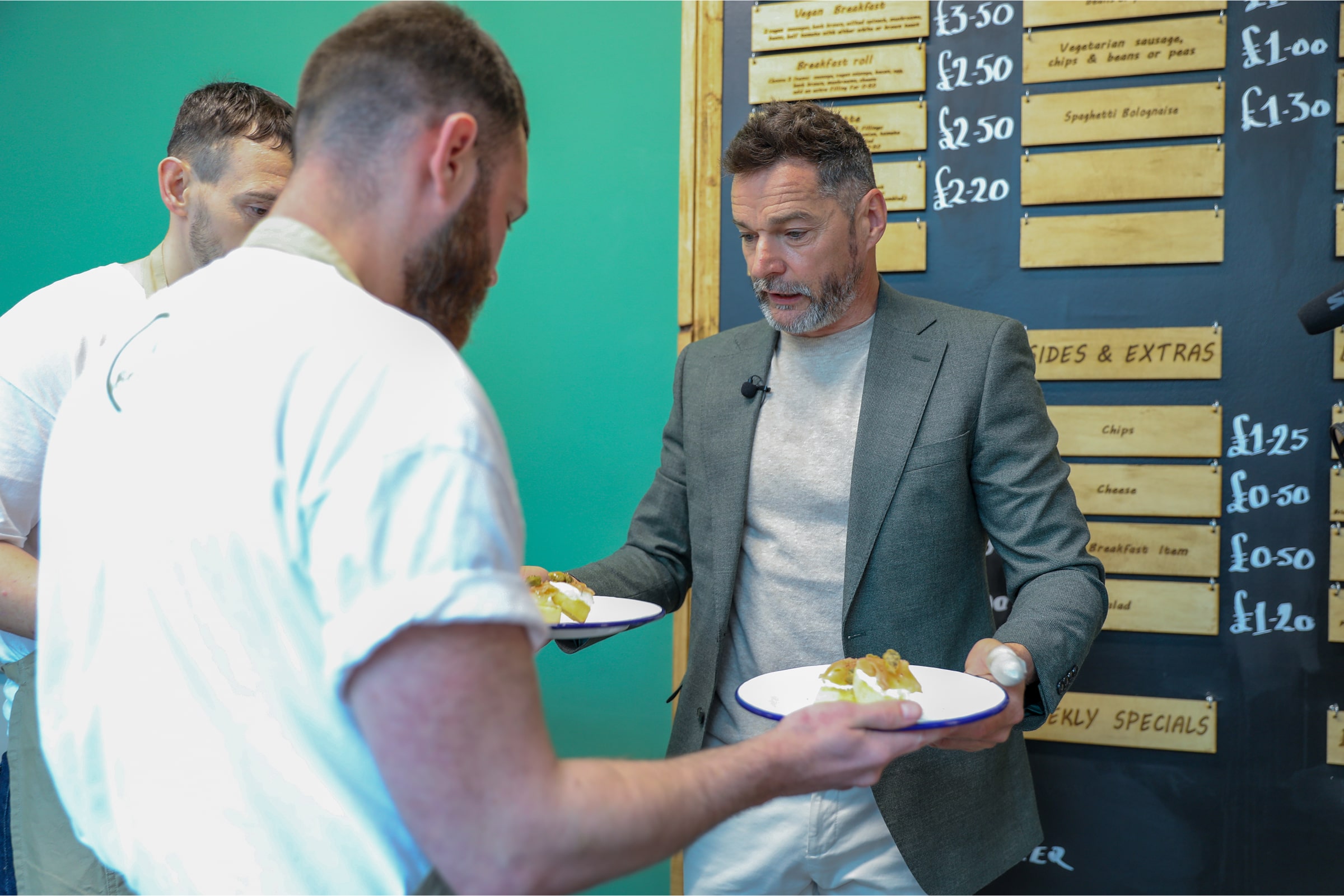Fred Sirieix shows prisoners how to correctly hold plates in a prison restaurant