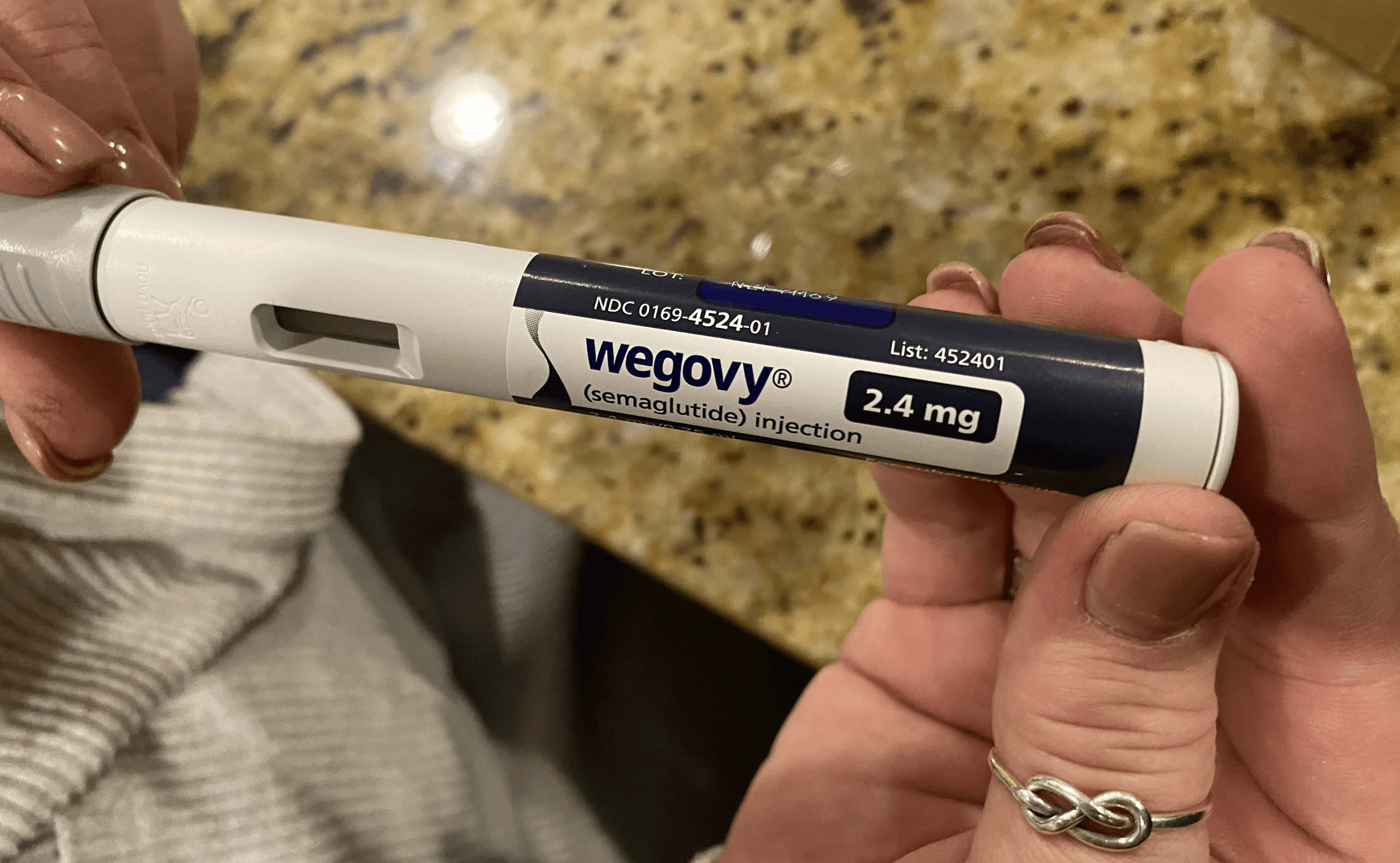 Person holding Wegovy semaglutide injection pen - Semaglutide Visceral Fat