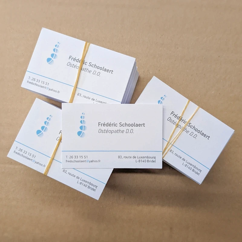 Stacks of business cards for Frédéric Schoolaert, Ostéopathe