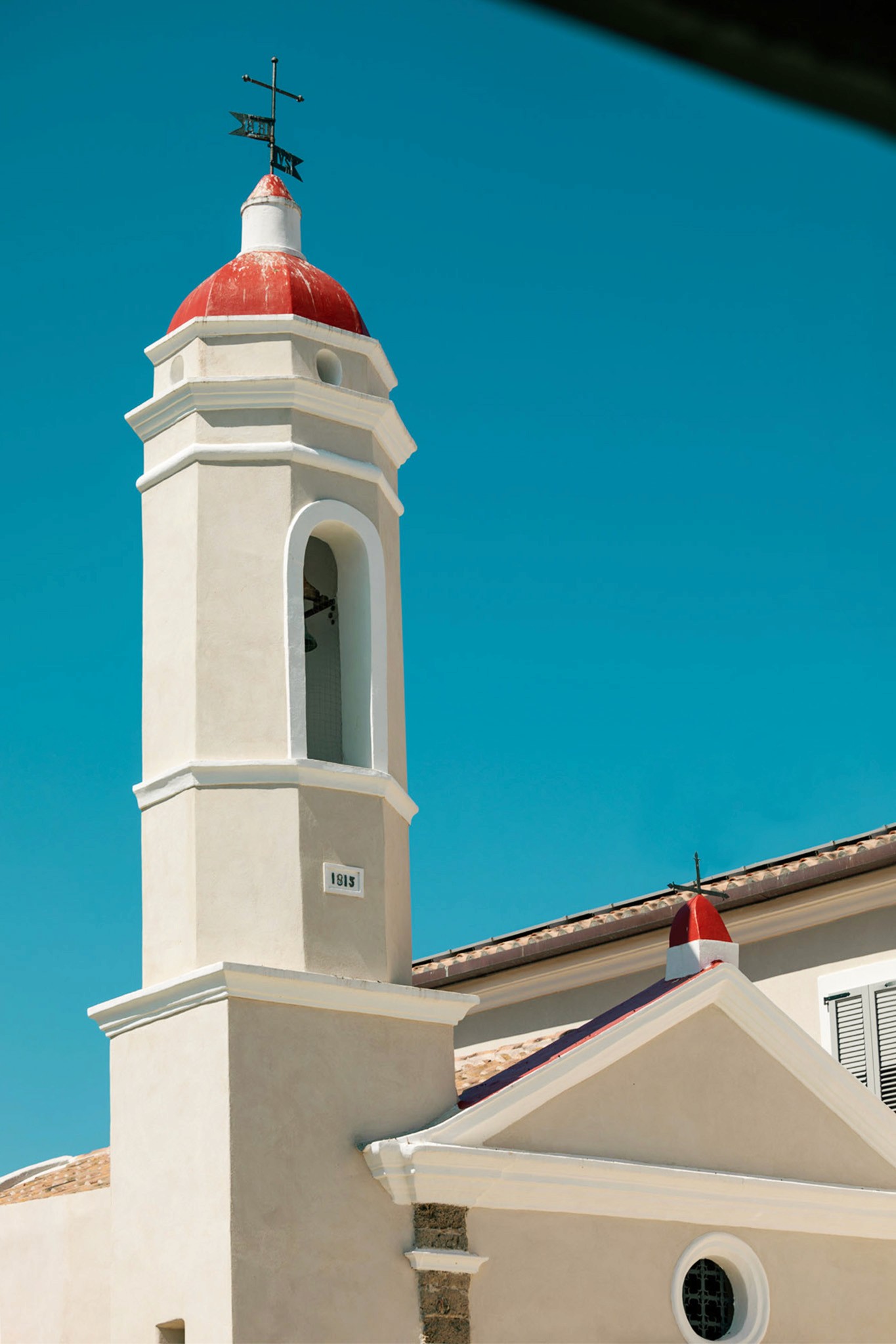 A person with short blonde hair holds a vintage camera.