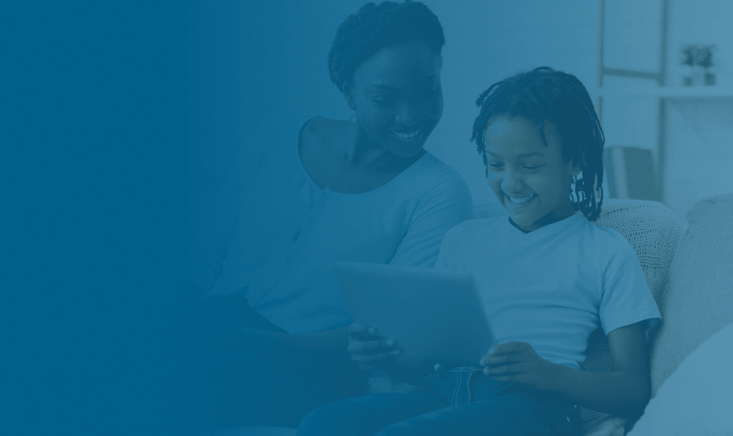 An image of a parent and a child looking at Impact Suite parent resources together. These resources equip families to keep students safe and supported. These resources are provided by the Raise app, make by Impact Suite.