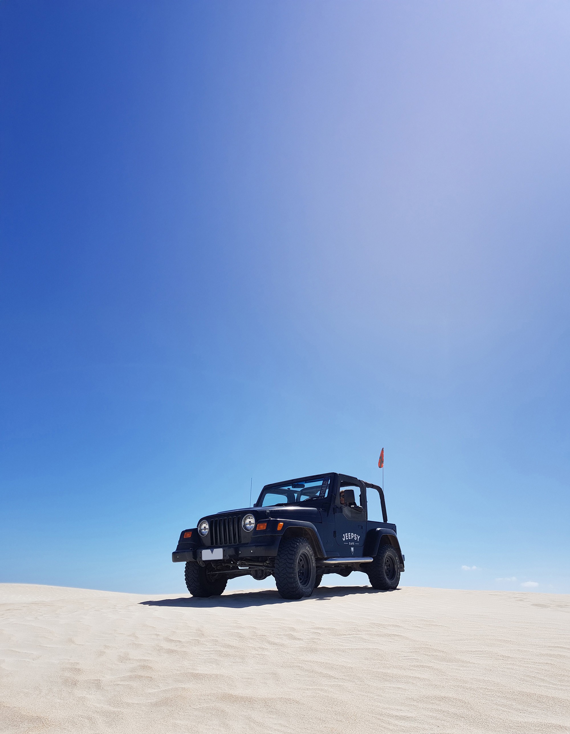 Dynamic picture of Jeep Wrangler on sand dunes