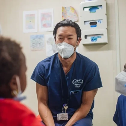 Hand holding a mobile phone showing an open position