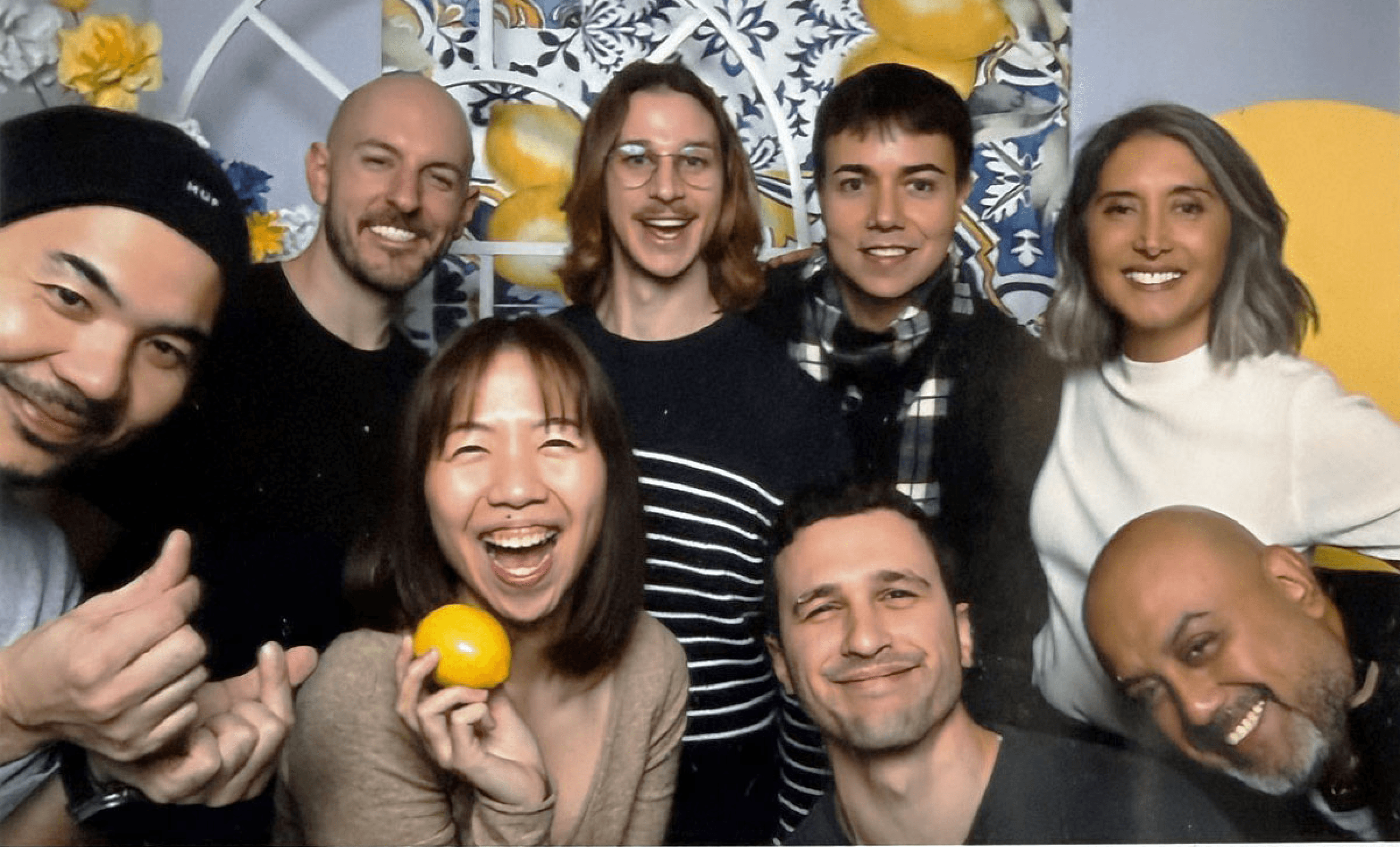 Black and white image of people working at a table with laptops, showing hands gesturing during discussion of digital content displayed on screens, with fabrica® logo in the corner.