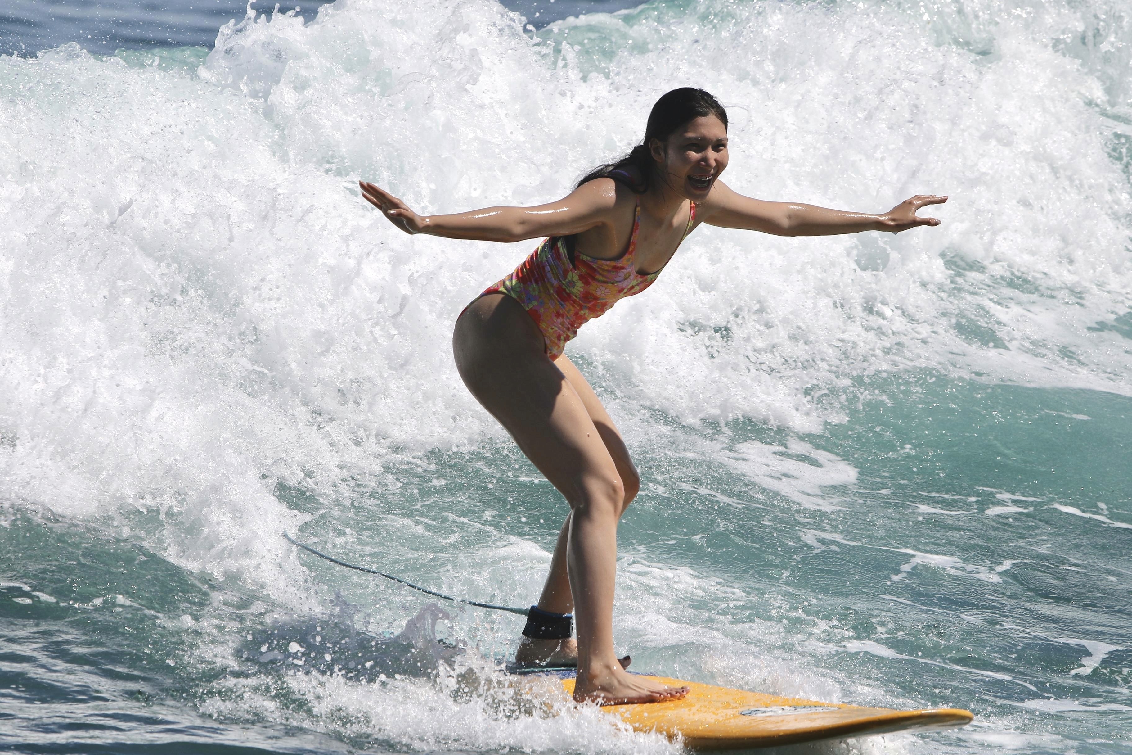 A man stading with Surfboard