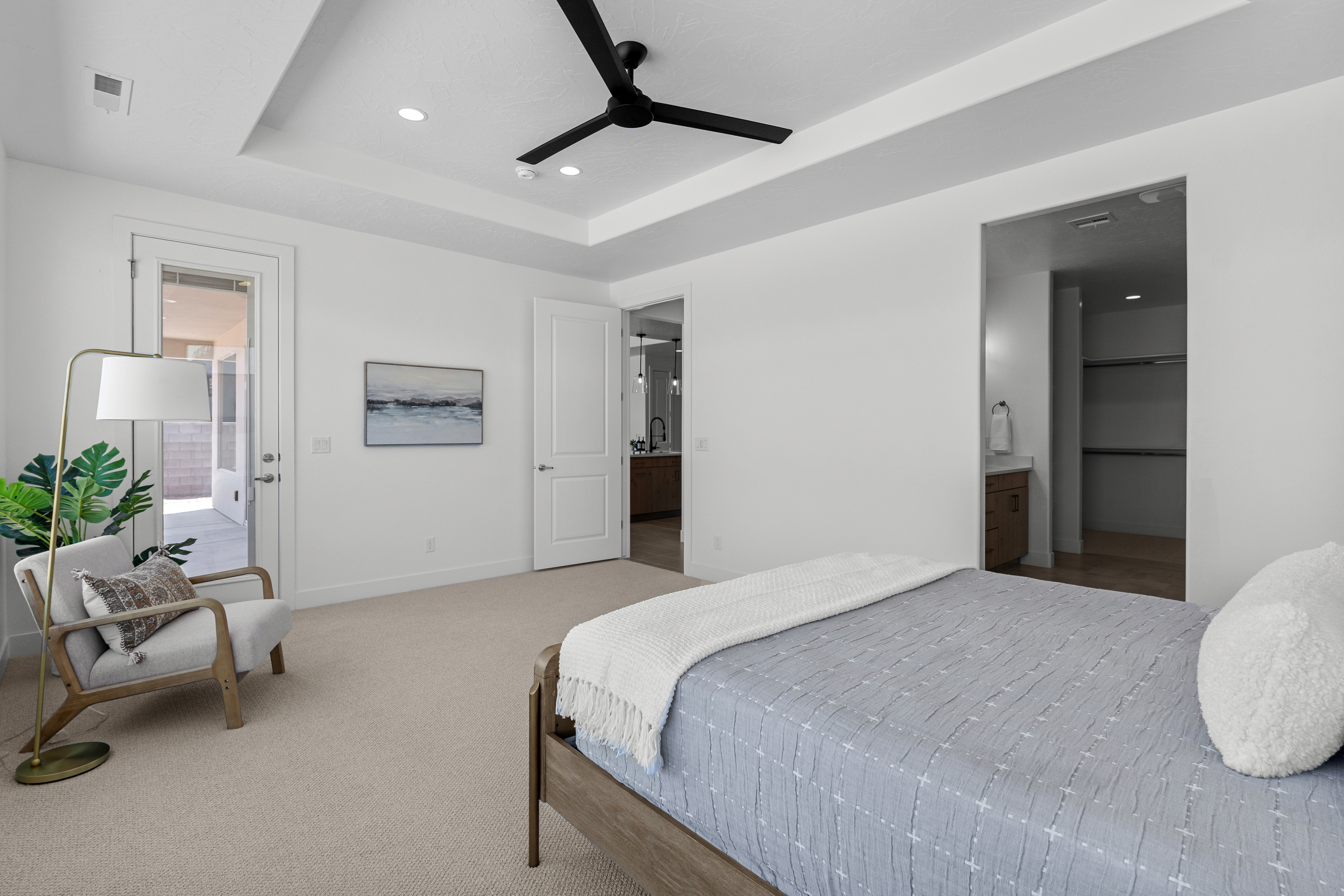 Master suite of The Nest at Falcon Ridge in Hurricane, Utah, featuring natural light and spacious layout.