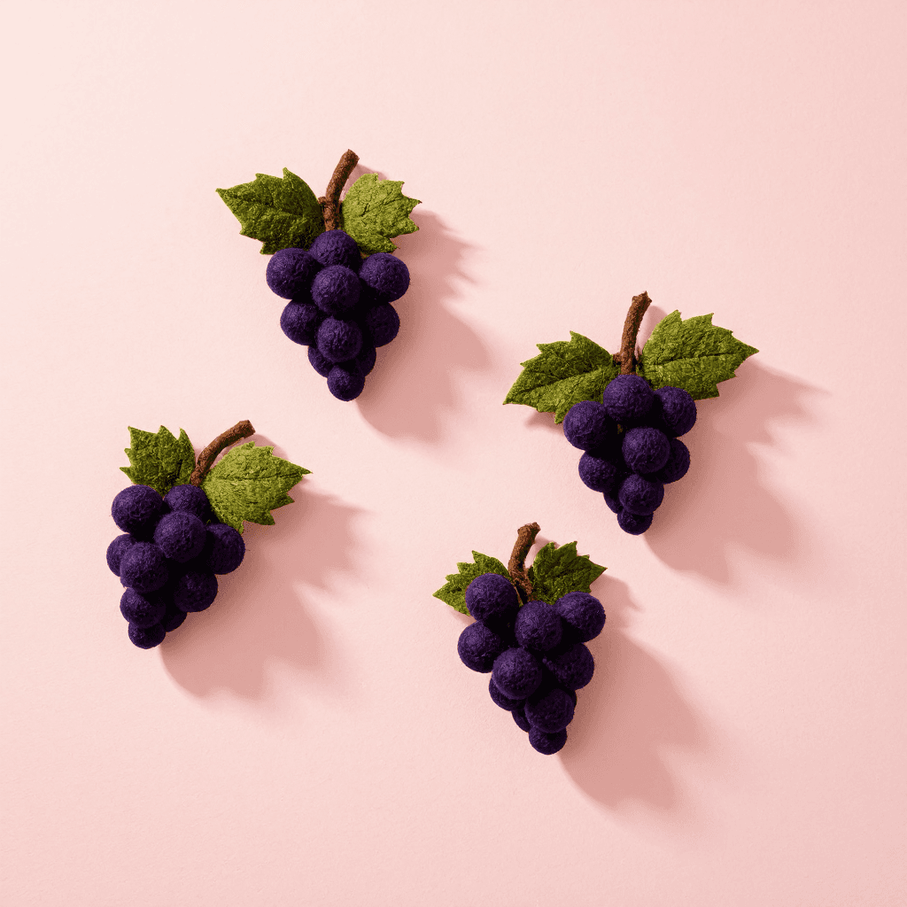 product photography of a set of grape-shaped felt decorations