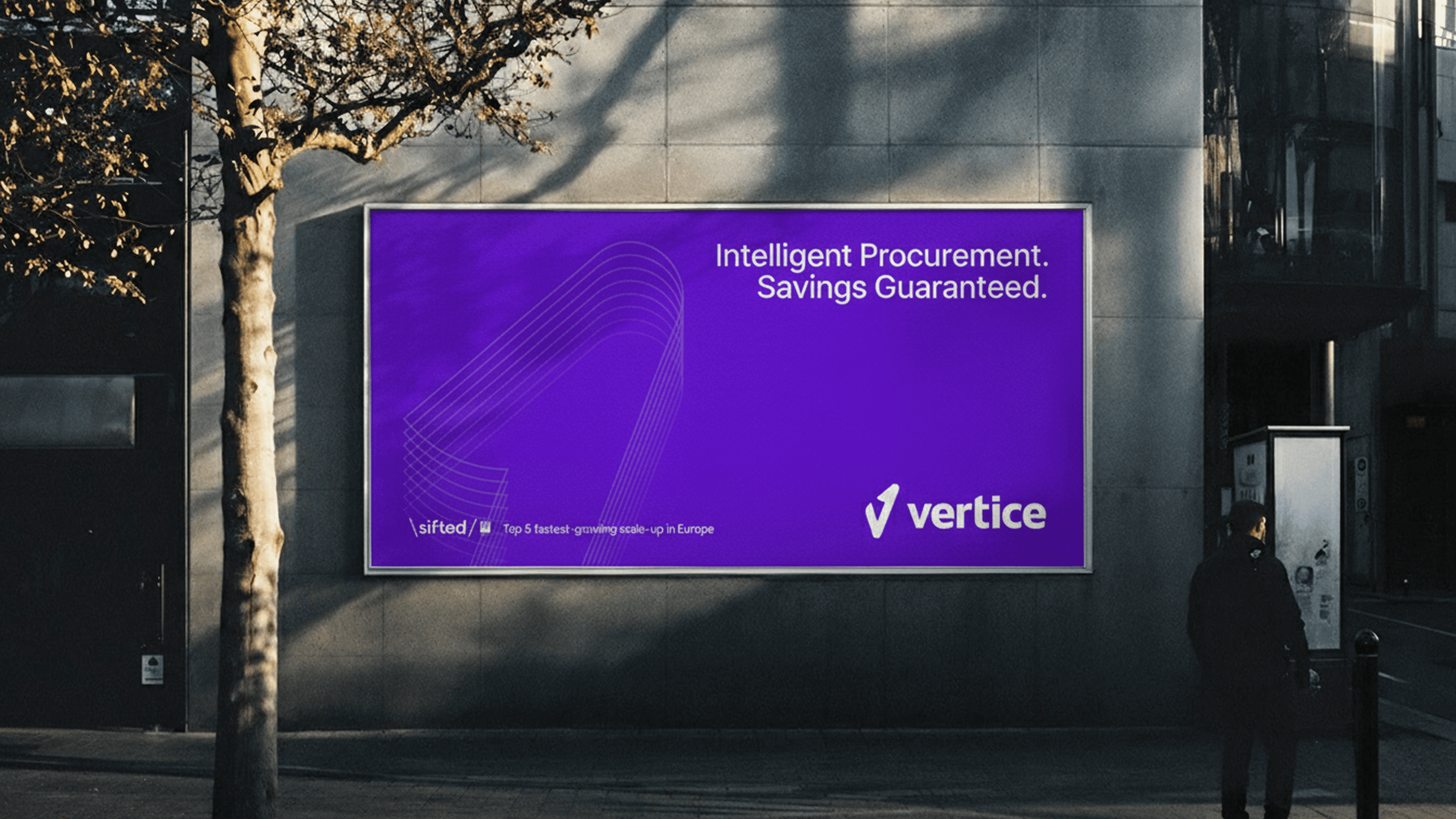 Modern home office setup with a monitor, ergonomic chair, keyboard, and indoor plants near a window with blinds.