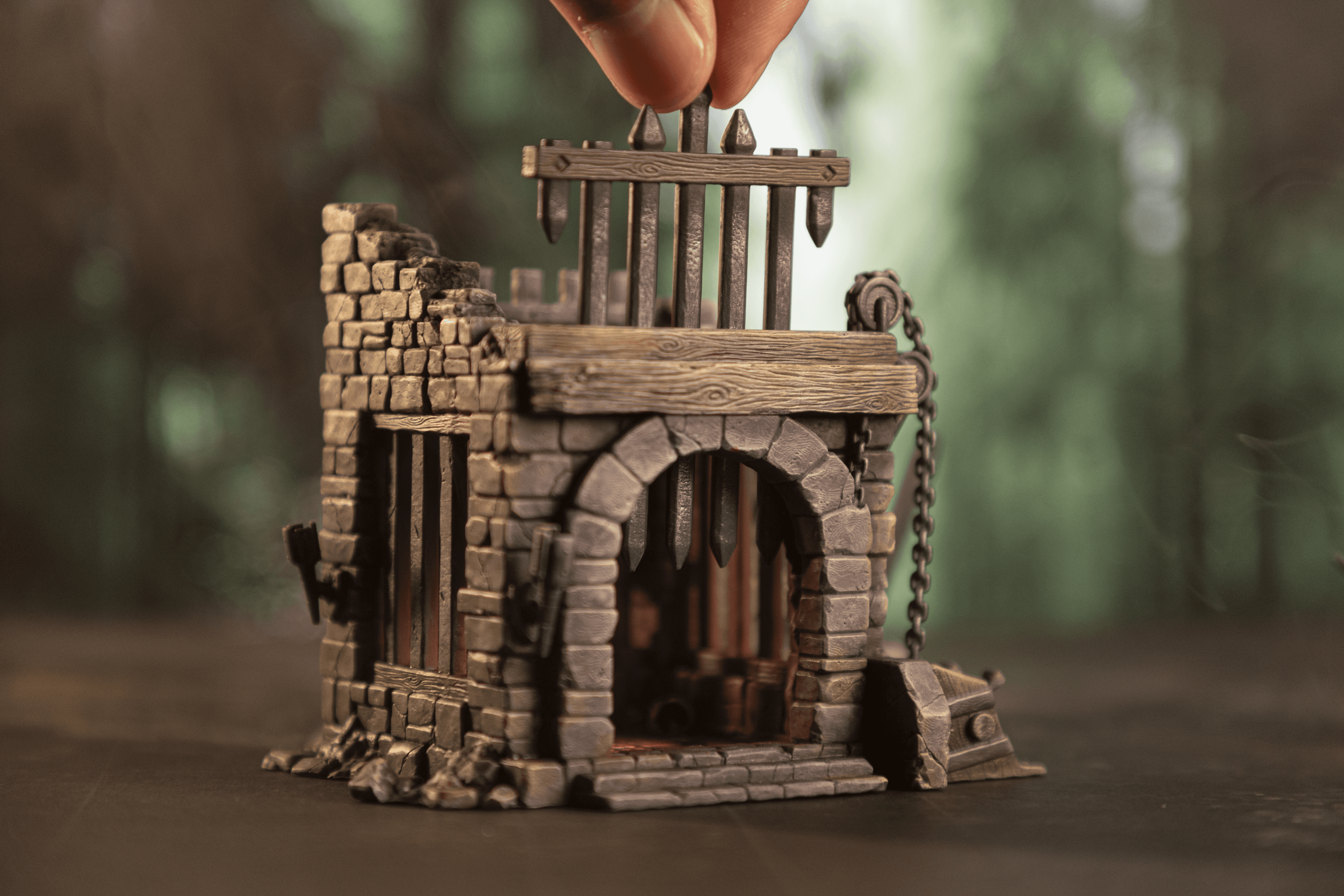 A person fingers reaching out to a miniature of an Troll