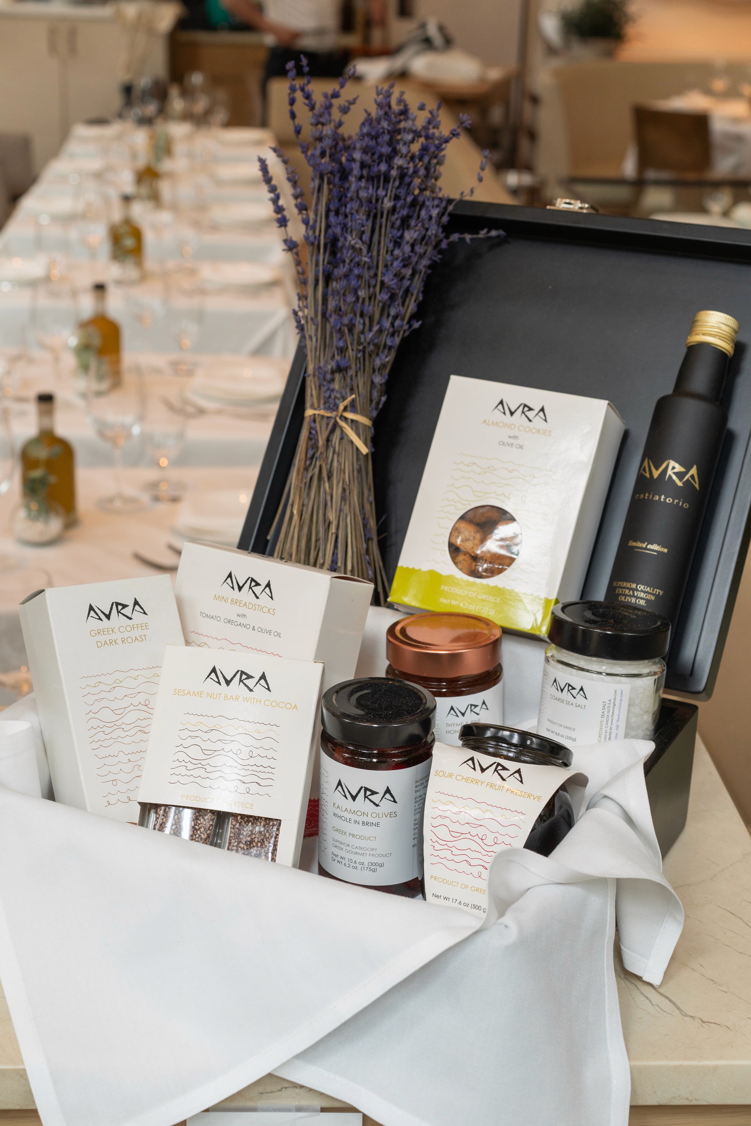 A flat lay arrangement of beauty and skincare products on a textured surface, featuring various containers and tools.