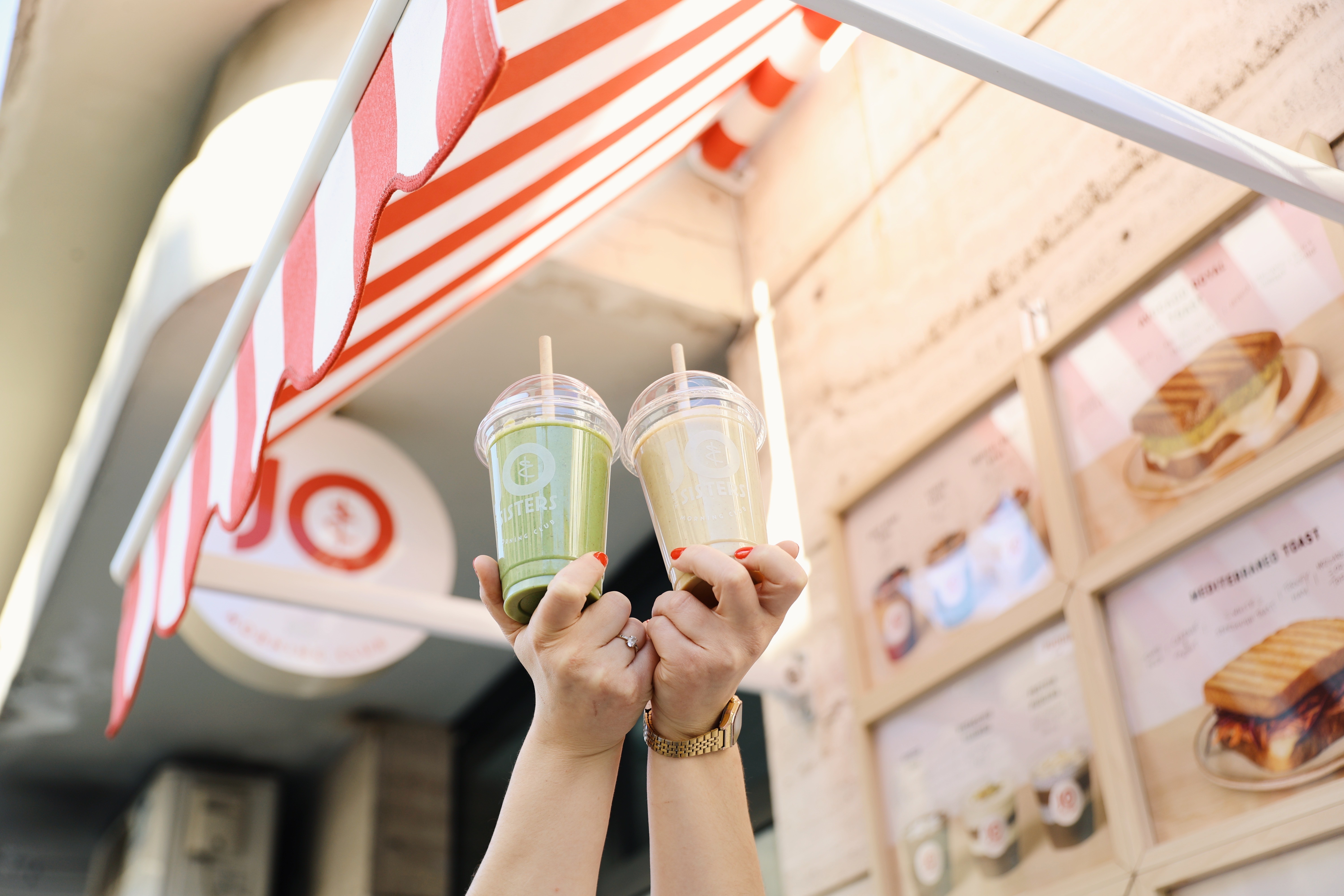 woman in black tank top holding clear wine glass