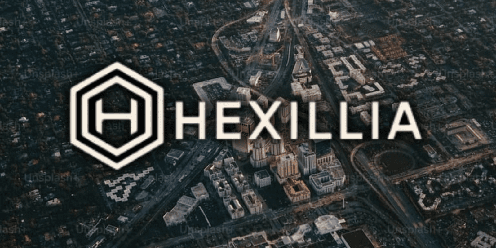 Aerial view of a city with Hexillia branding overlaid, showcasing urban landscape, roads, and buildings in soft light.