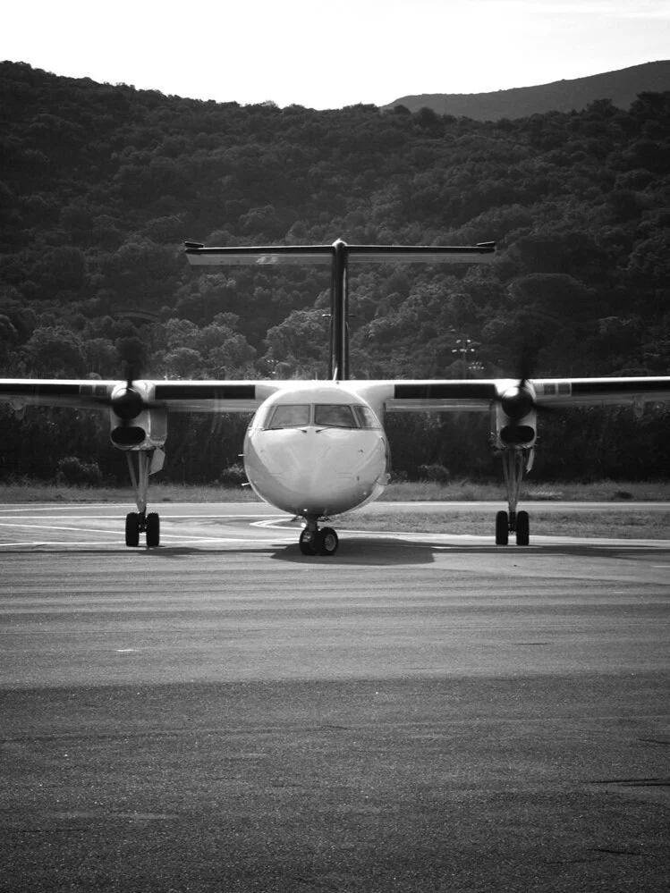 Luxury private jet interior with rows of comfortable leather seats and mood lighting