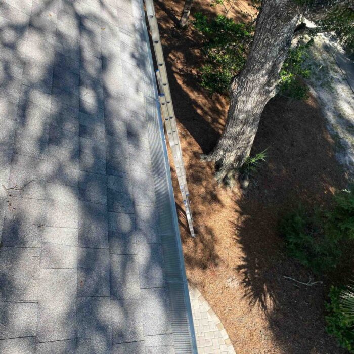 Before and after—gutter cleaned in Hilton Head SC, clear water flow restored after debris removal.