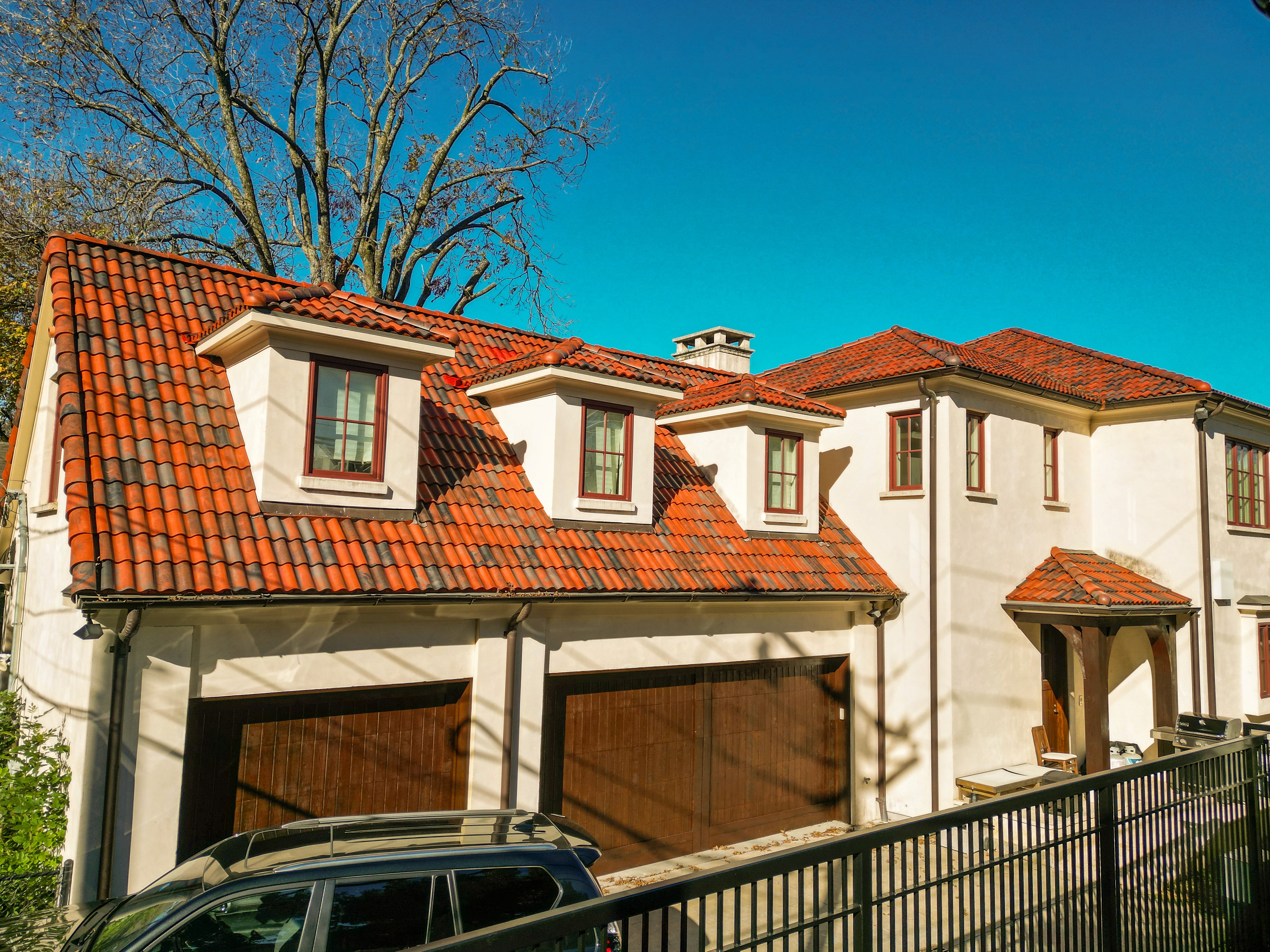 Tile roof replacement on a University Park stucco home — front-angled view
