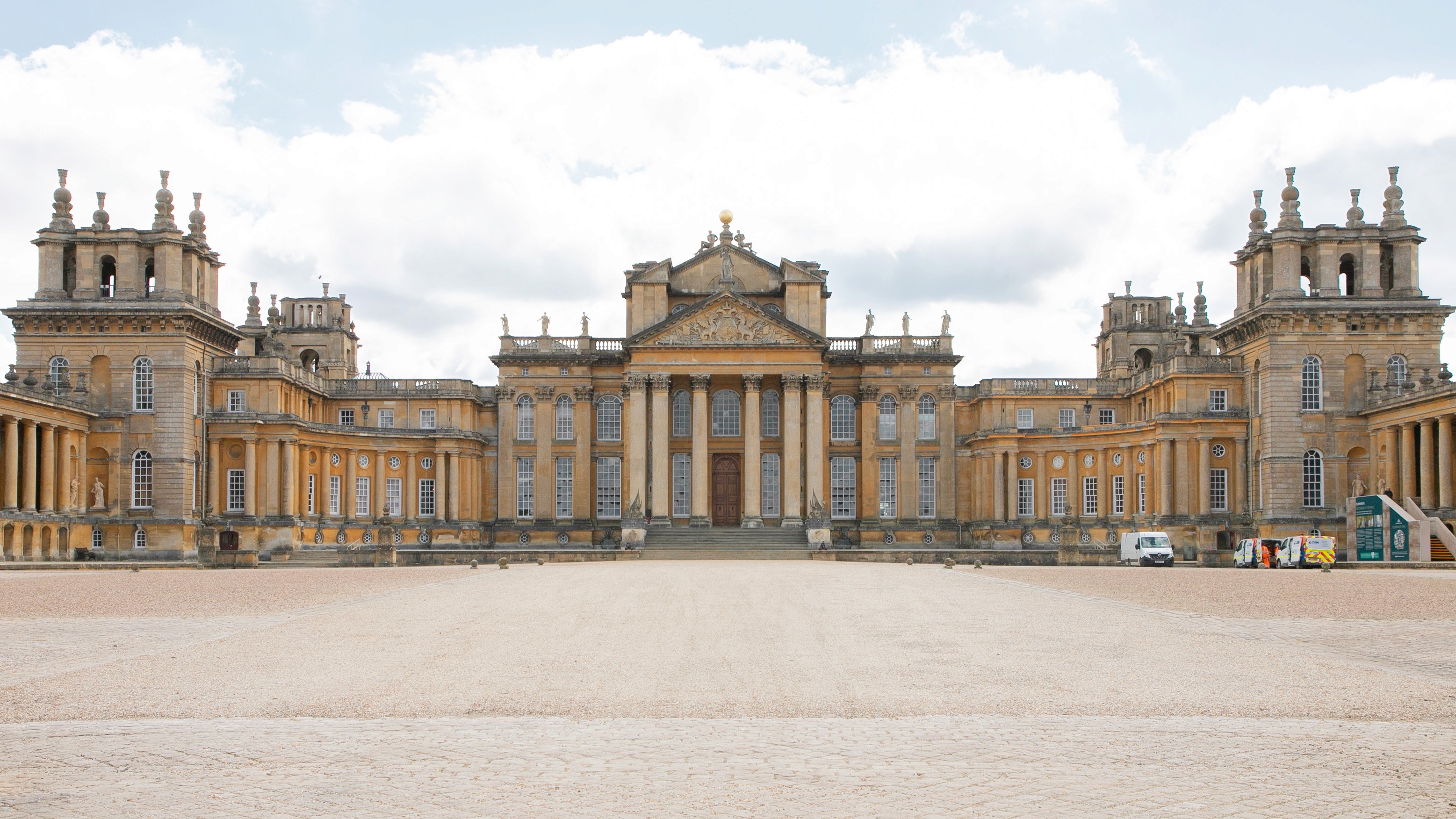 Two classic volkswagen beetles, one green, one cream.