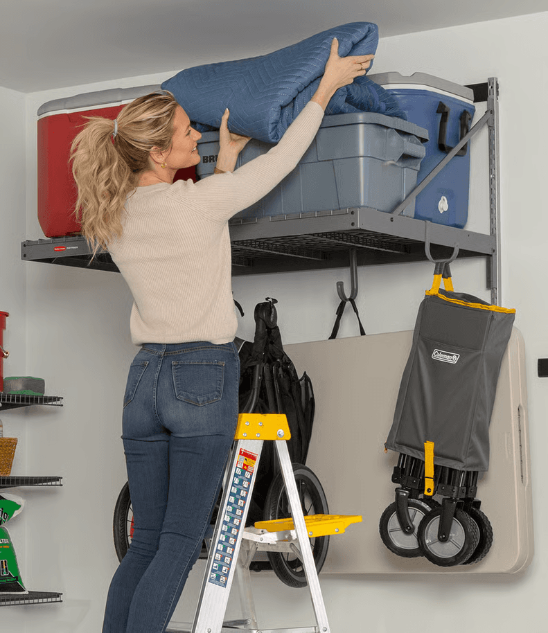FastTrack overhead shelf and hooks holding coolers, bags, and a rolling cart in a garage