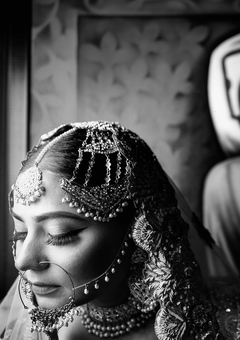 A man sits confidently on a chair positioned center stage, engaging with the audience.