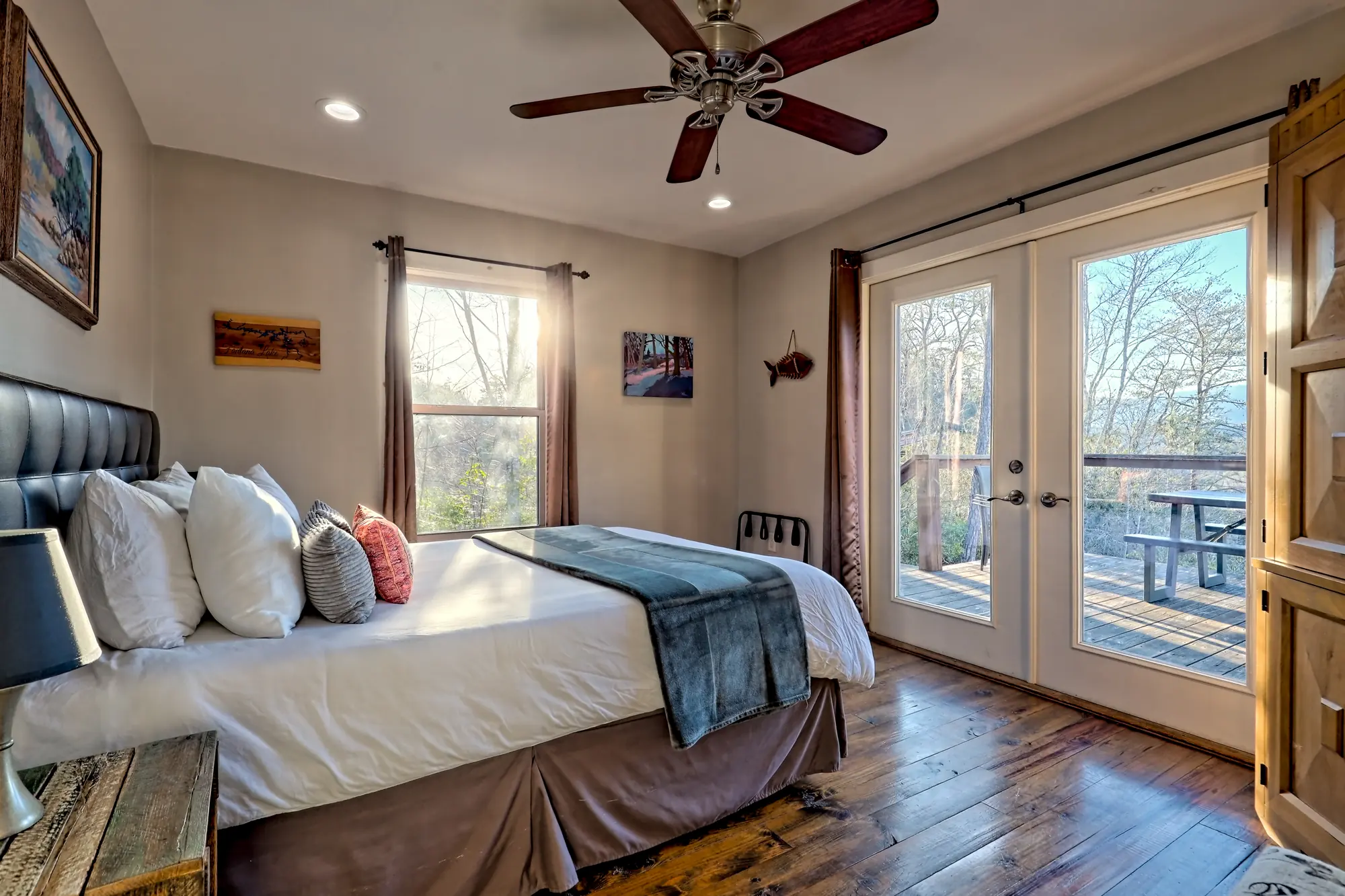Eagles Landing bedroom with a tufted headboard and French doors to the deck