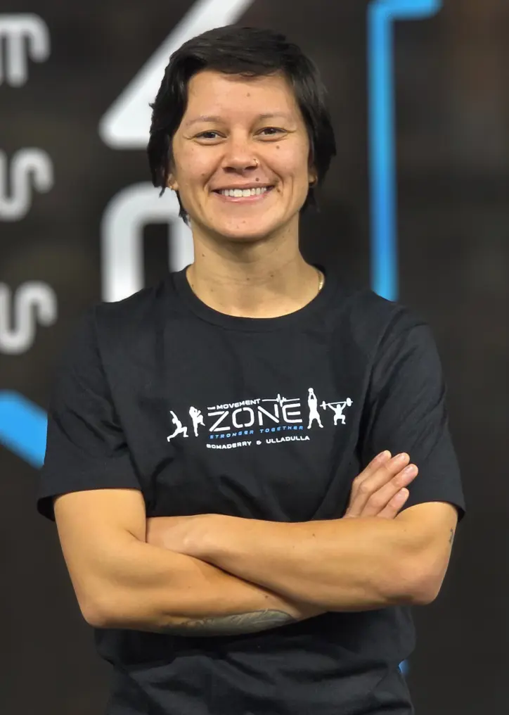 Coach Scott Richardson in The Movement Zone shirt posing in the gym.