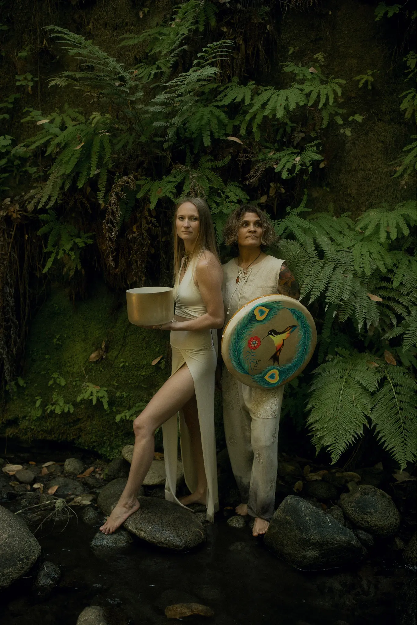 Emeline and Sonia standing together on jungle rocks representing the next step into transformation