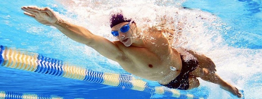 A swimmer performing a freestyle stroke in a pool