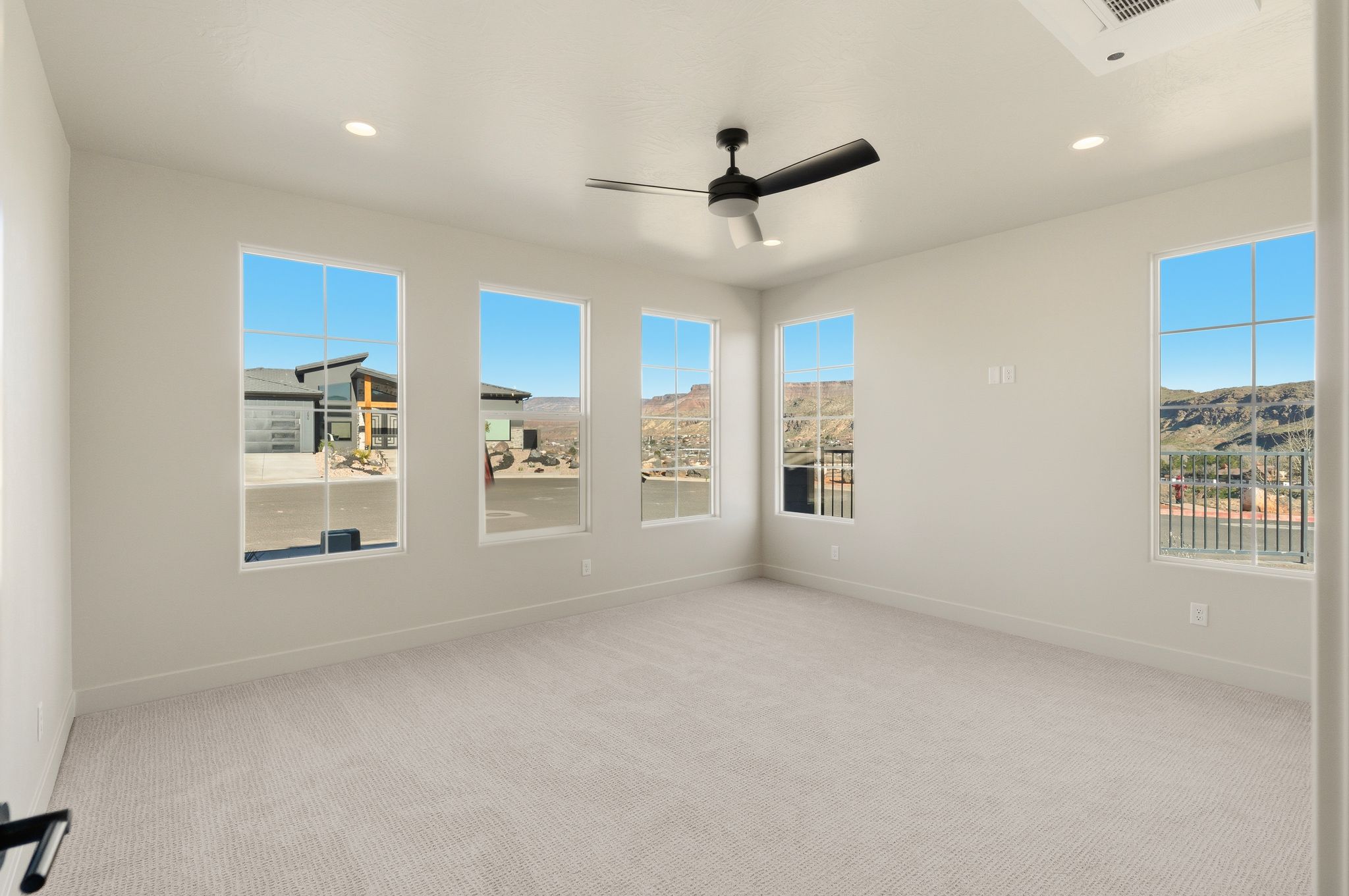Primary bedroom at The View at Falcon Ridge in Hurricane, Utah, featuring a spacious layout and access to natural light.