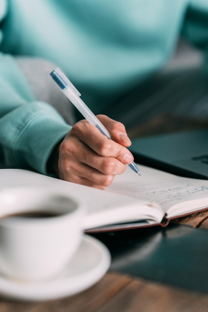 A patient signing a notebook,