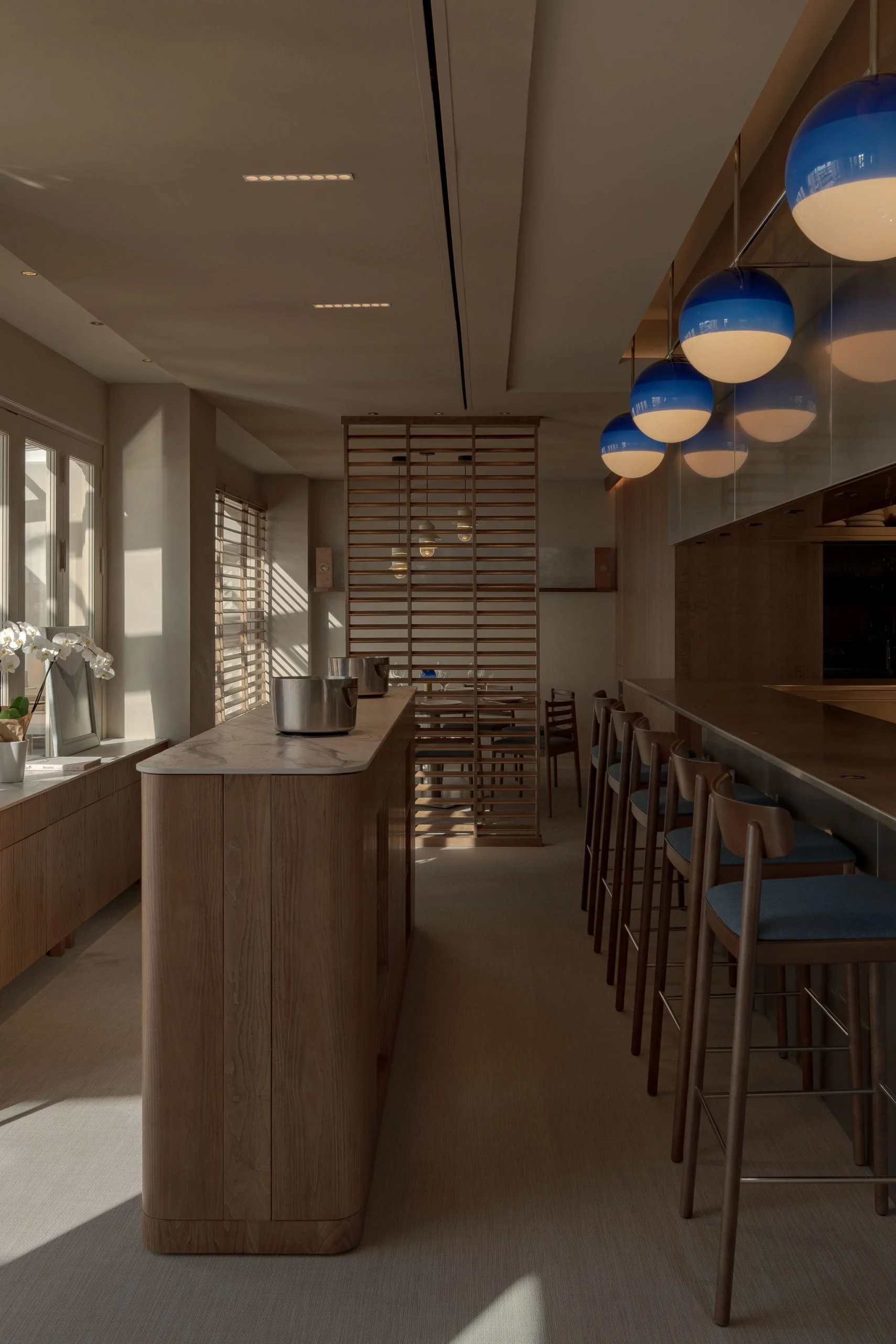 Golden cross atop a domed building with blue sky.