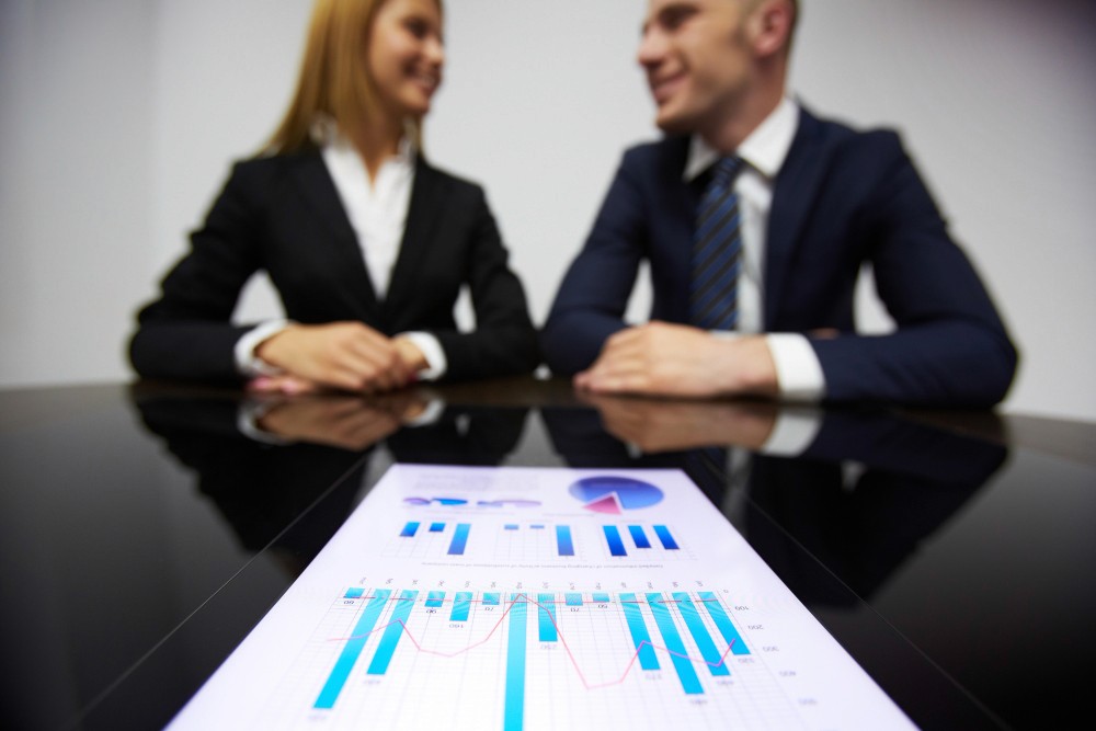 Business owner reviewing financials and contracts while preparing a business for sale