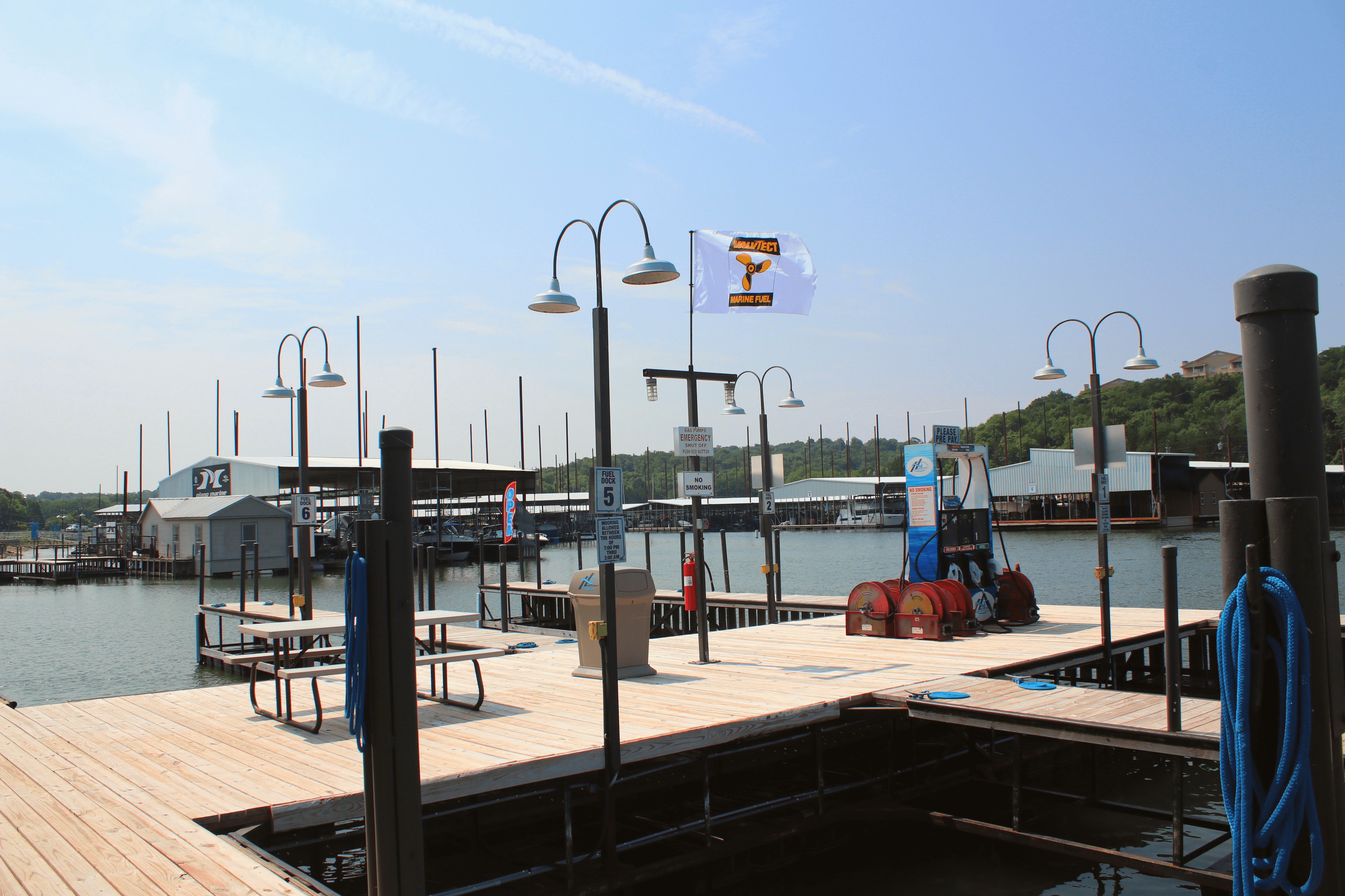 A man standing on a boat in a marina