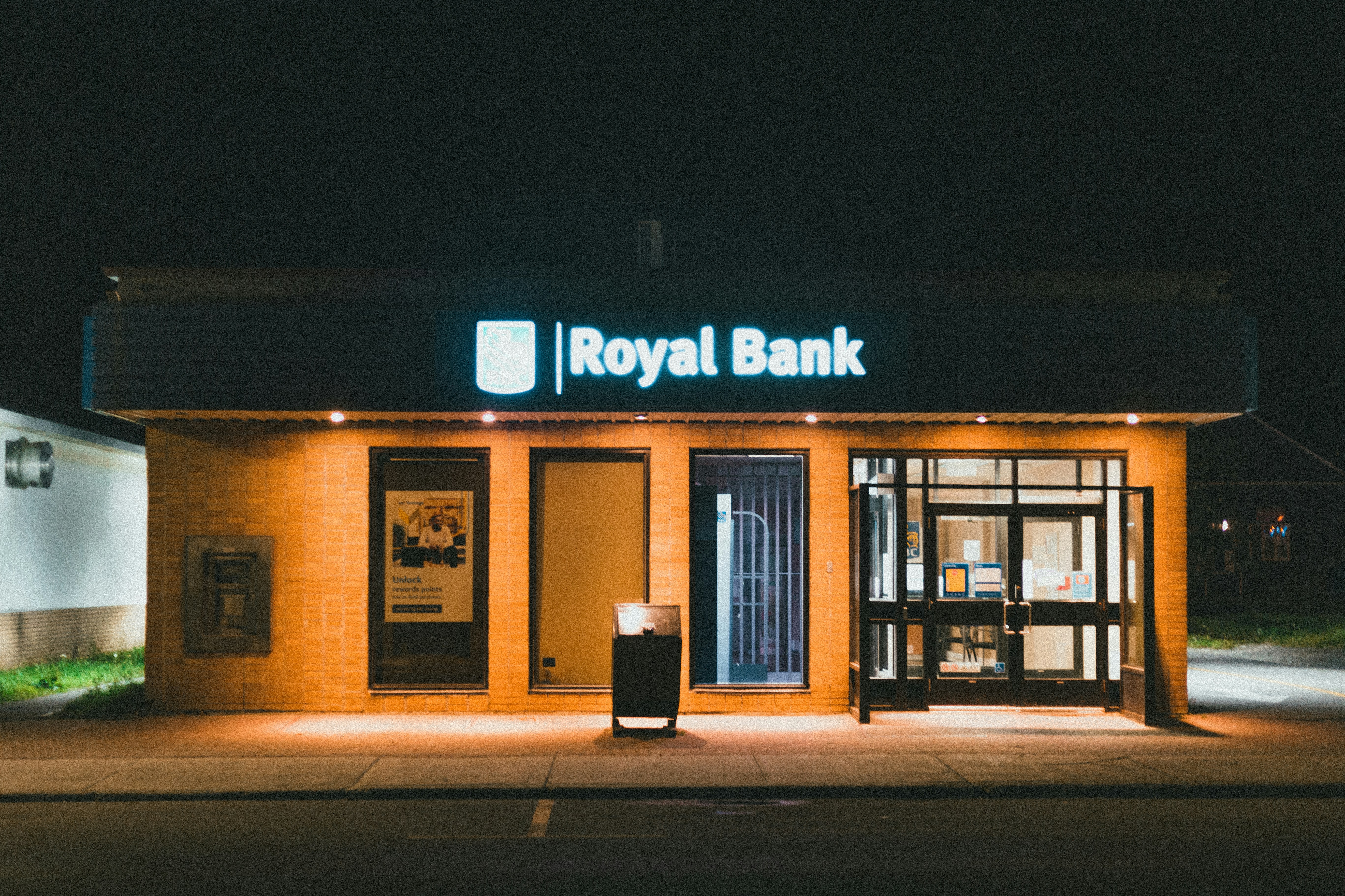 Modern bank branch front view at night
