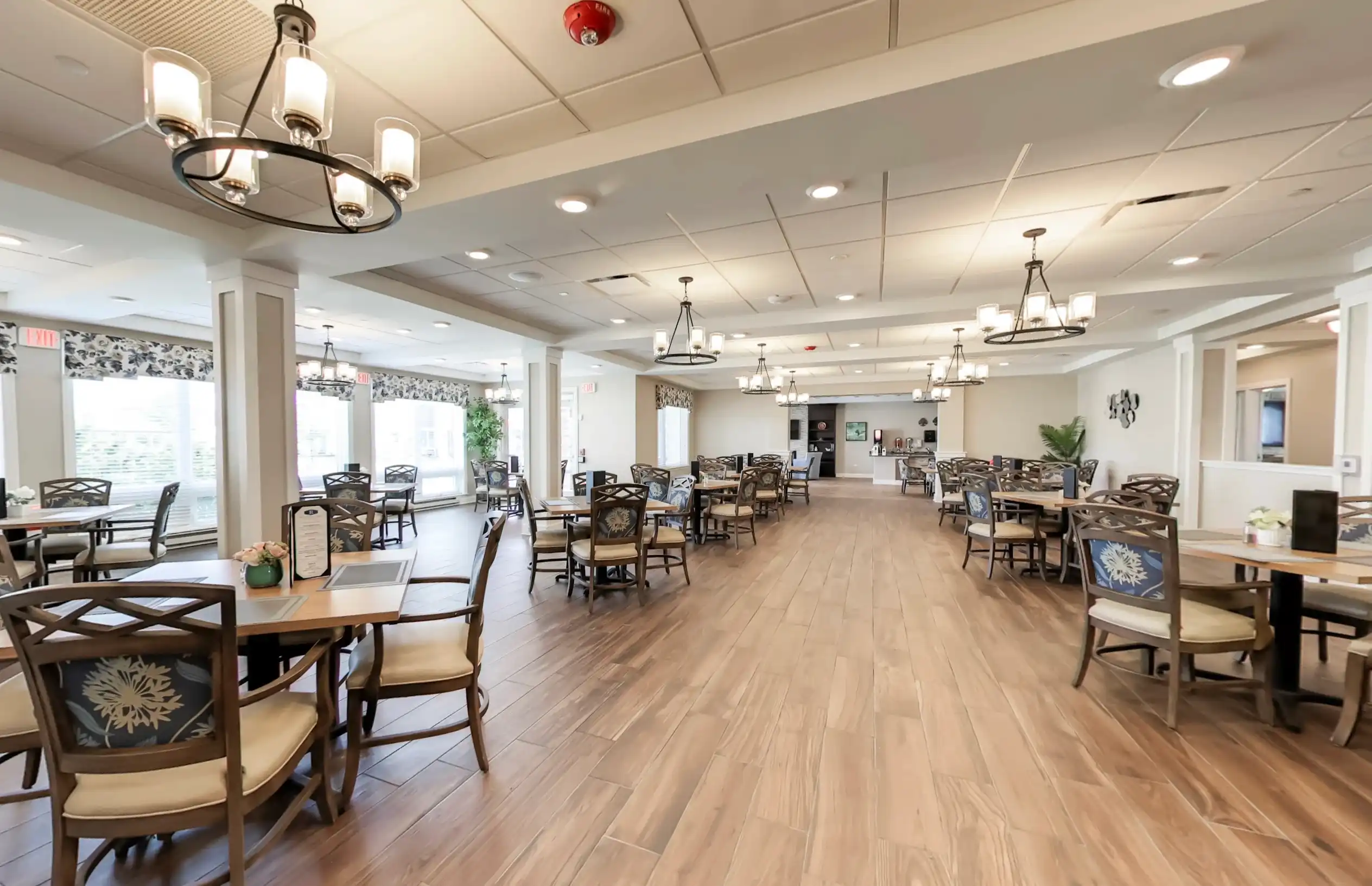 Elegant dining room with wood flooring and chandeliers