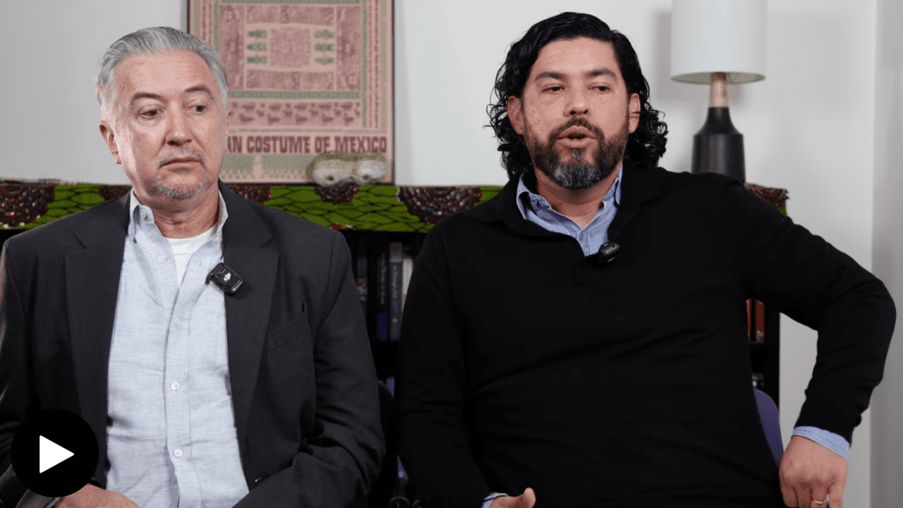 John Connelly on the left, and Freddy Janka on the right, seated in an office.