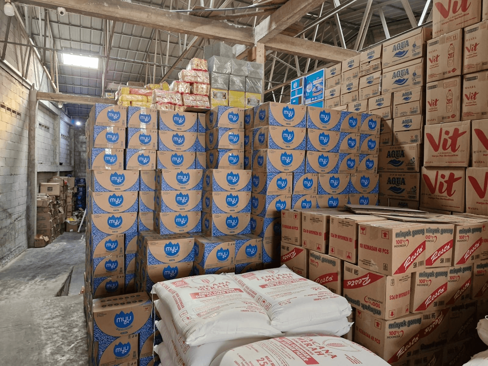 Stacked branded products in warehouse prepared for distribution with Baskit’s B2B logistics tools